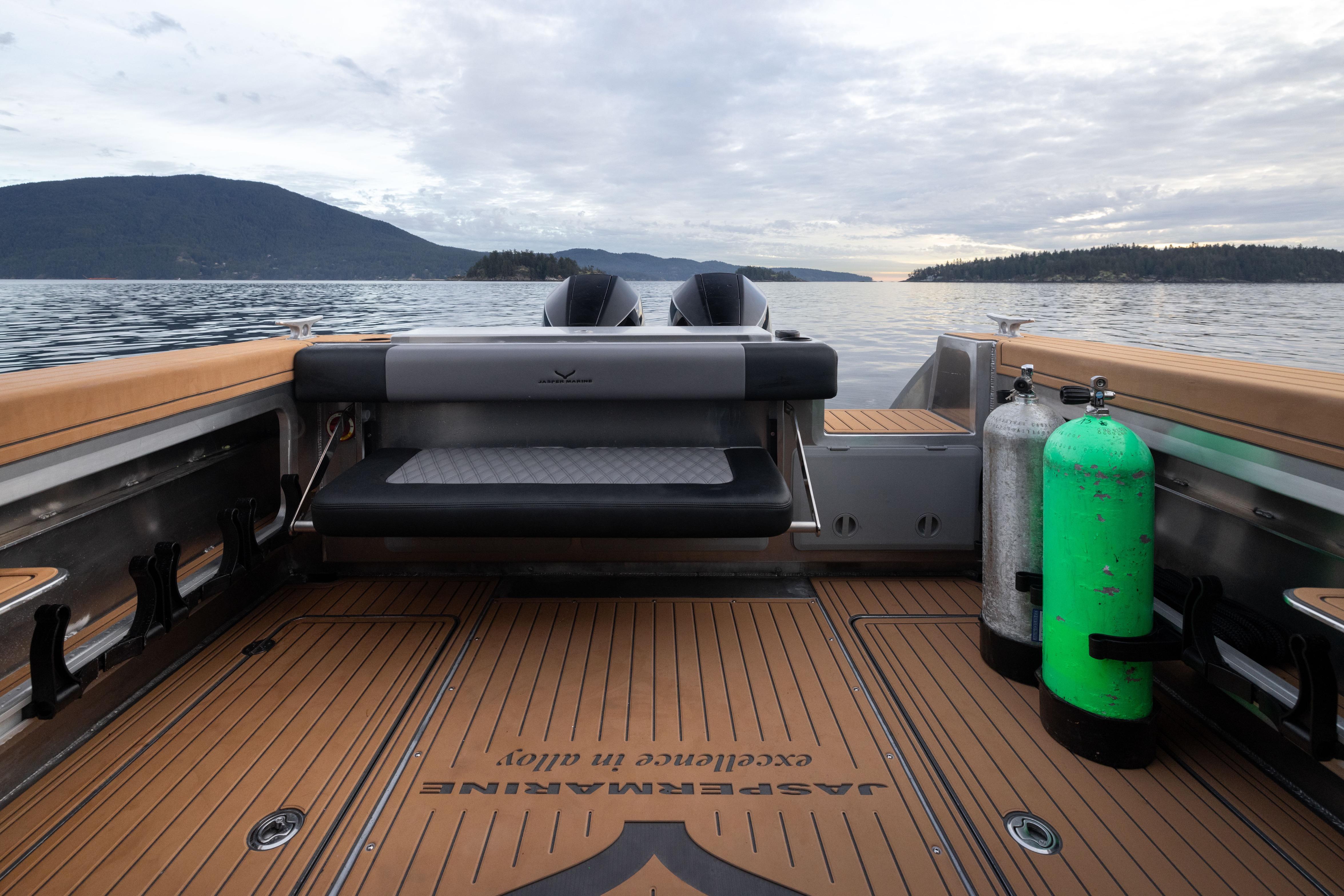2026 Jasper Marine Defender 22 boat interior with diving gear, scenic lake view.