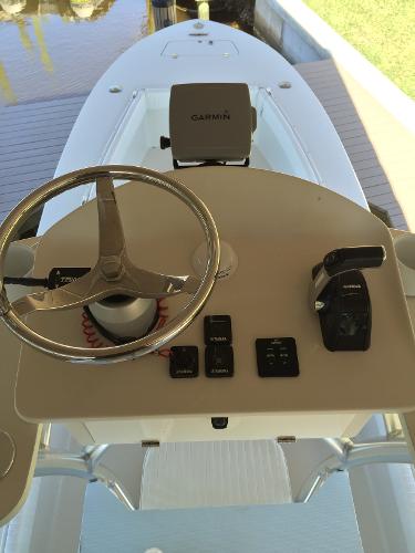 The image shows the helm of a 2011 Andros 26 Tarpon boat with a Garmin device.
