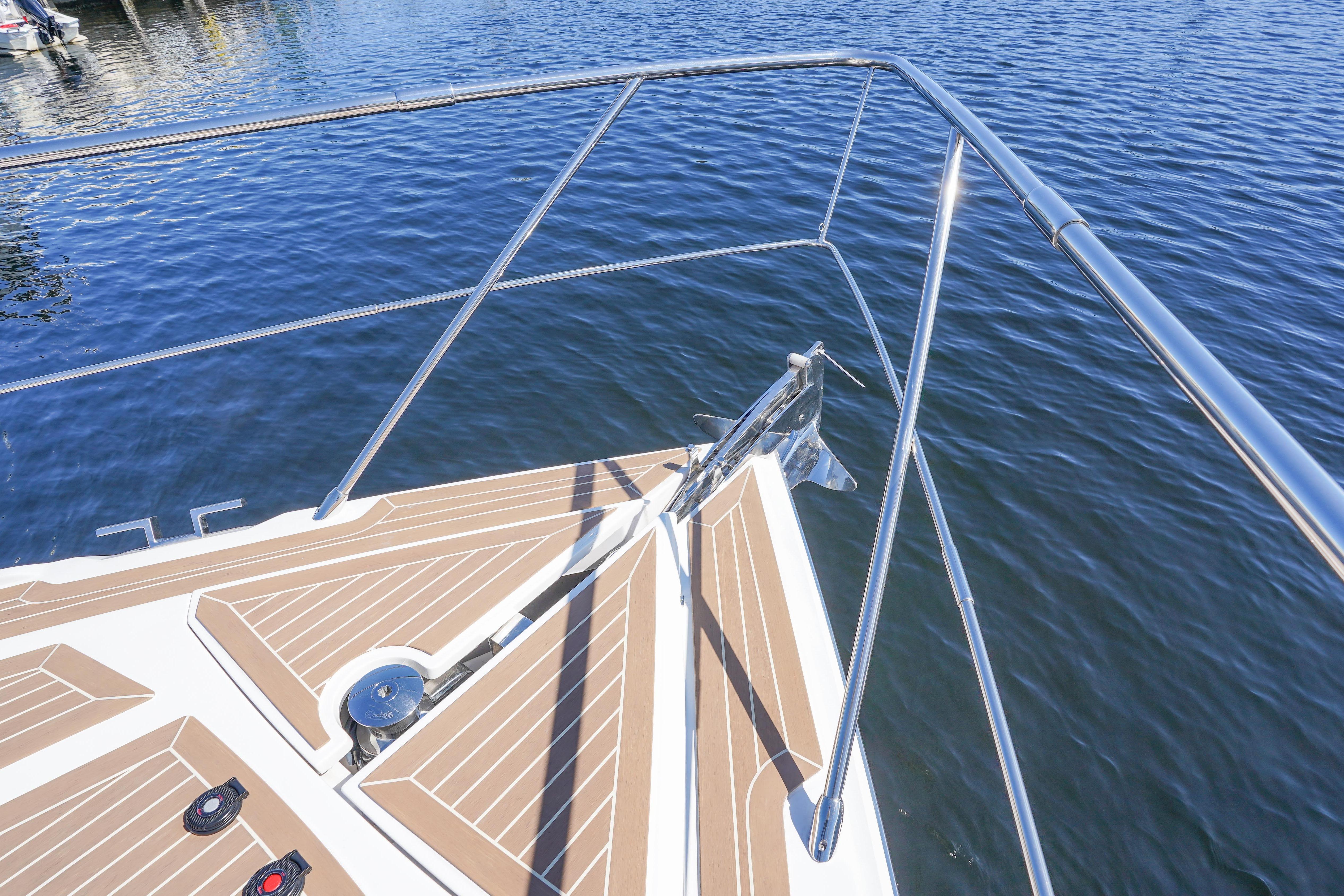Bow of 2019 Rio Yachts Colorado 56 with stainless steel railings on water.