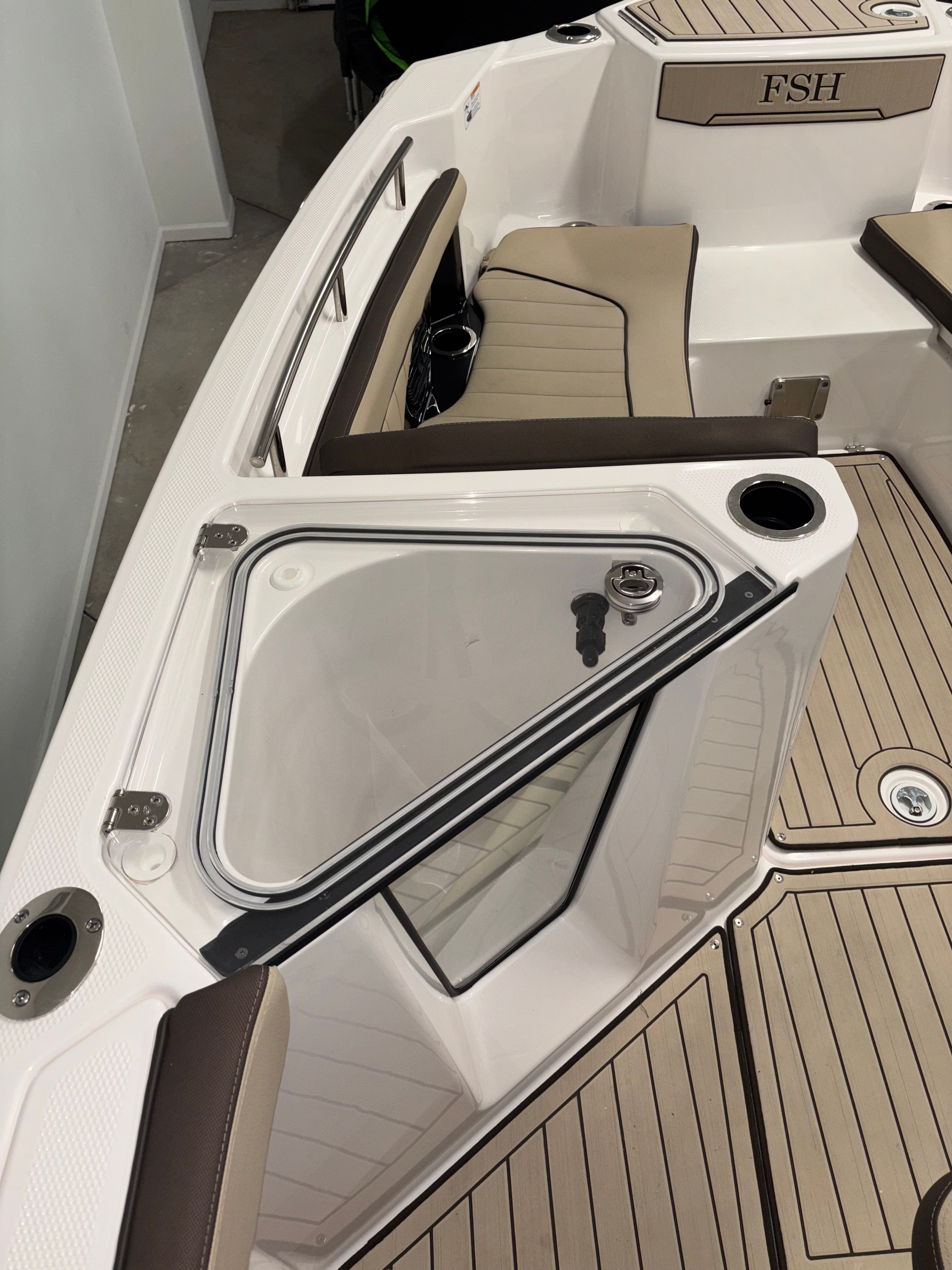 The image shows the deck of a Yamaha 222 FSH Sport E boat with sleek seating and modern details.