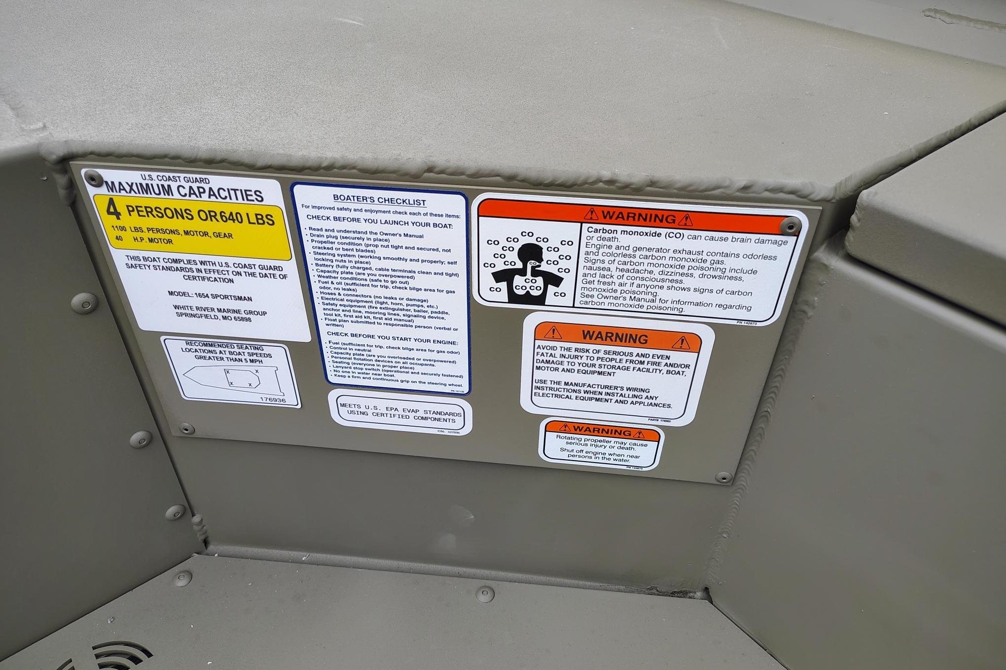 2026 Tracker Grizzly 1654 T Sportsman safety and capacity labels on boat interior.