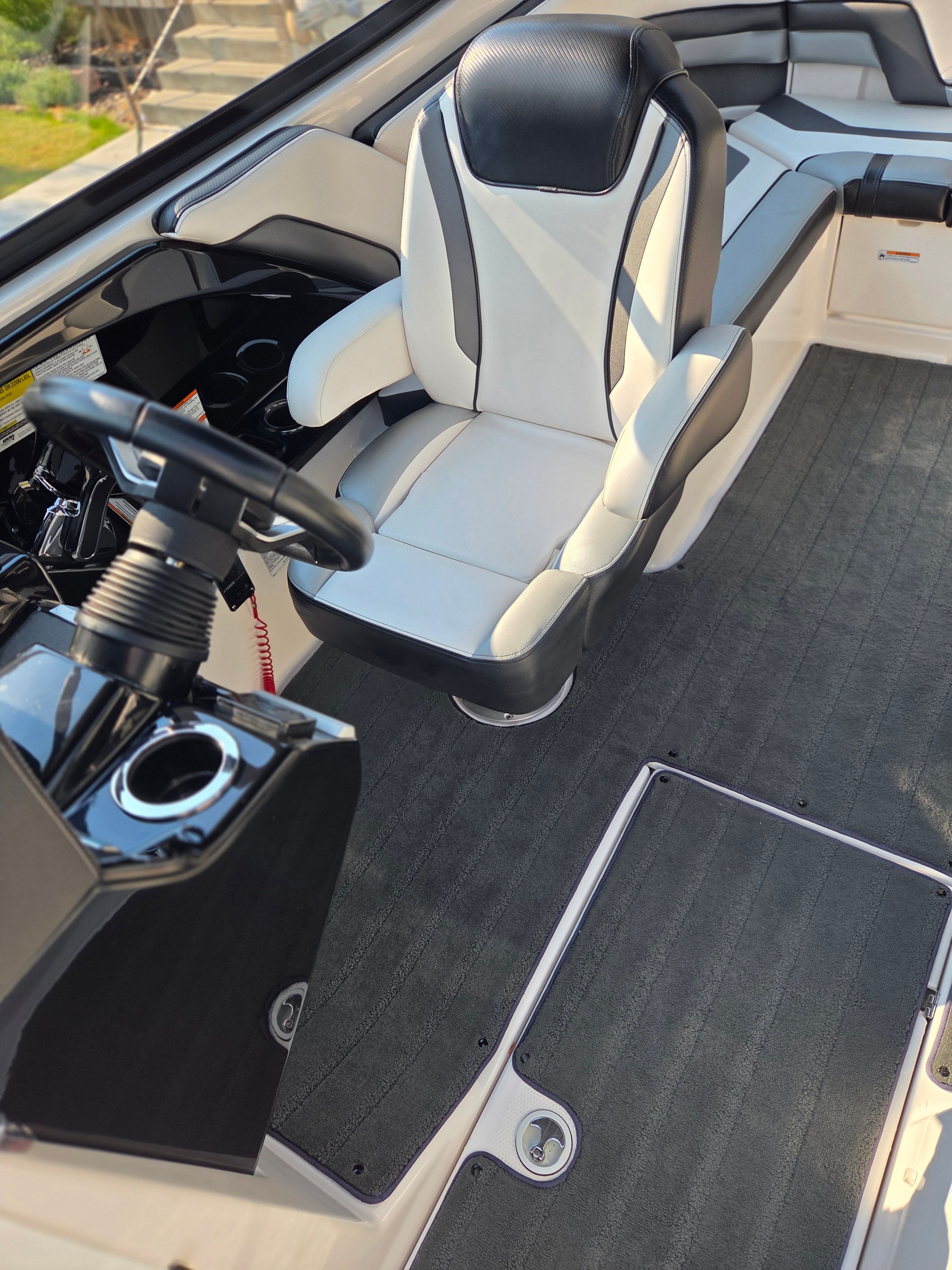 The image shows the interior of a 2016 Yamaha 242X E-Series boat with a cushioned seat and helm.