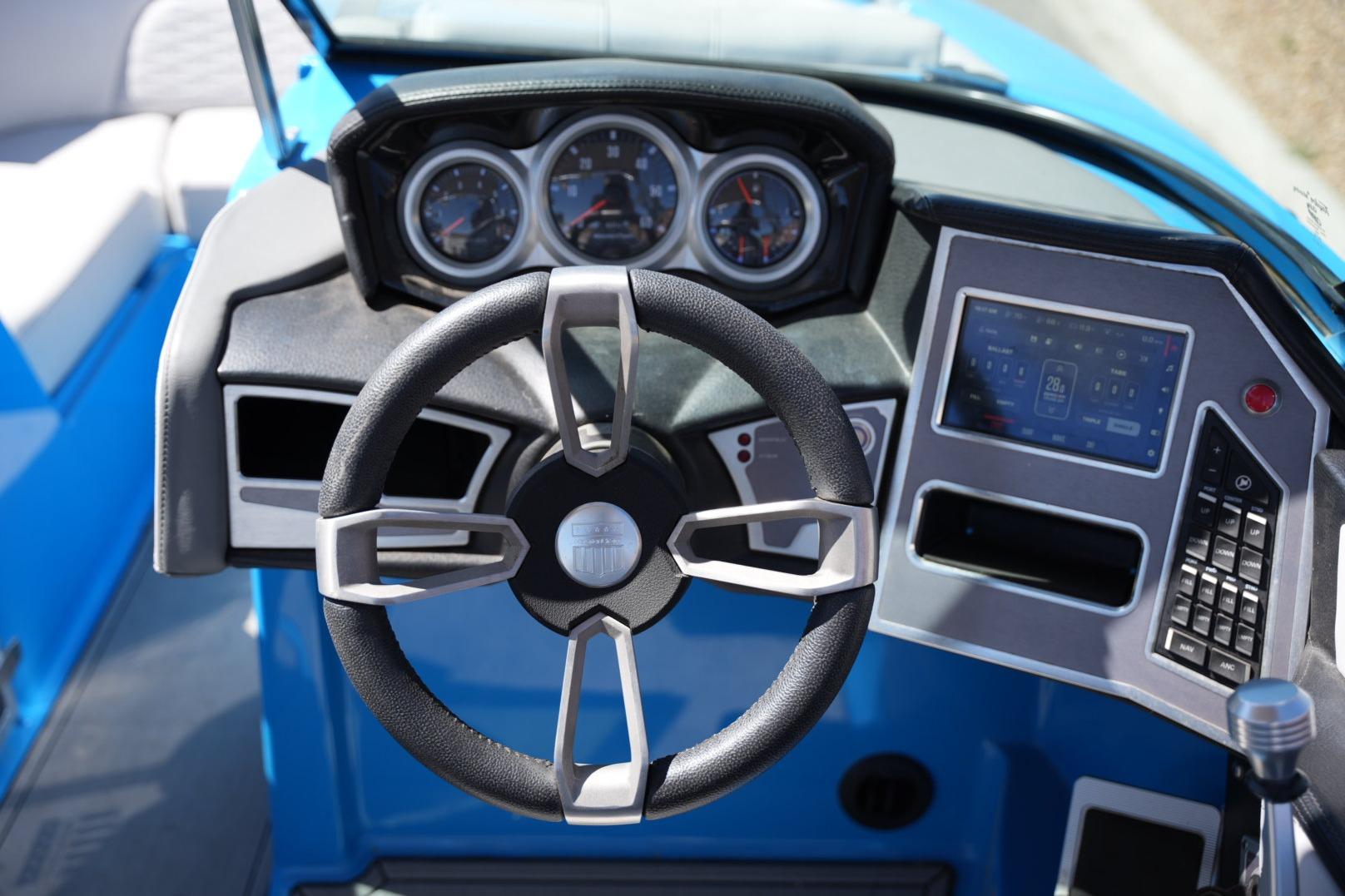 2020 MasterCraft X22 boat dashboard with steering wheel and digital display.