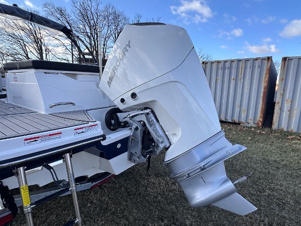 2025 Sea Ray SPX 230 OB boat with Mercury outboard engine, parked on grass.