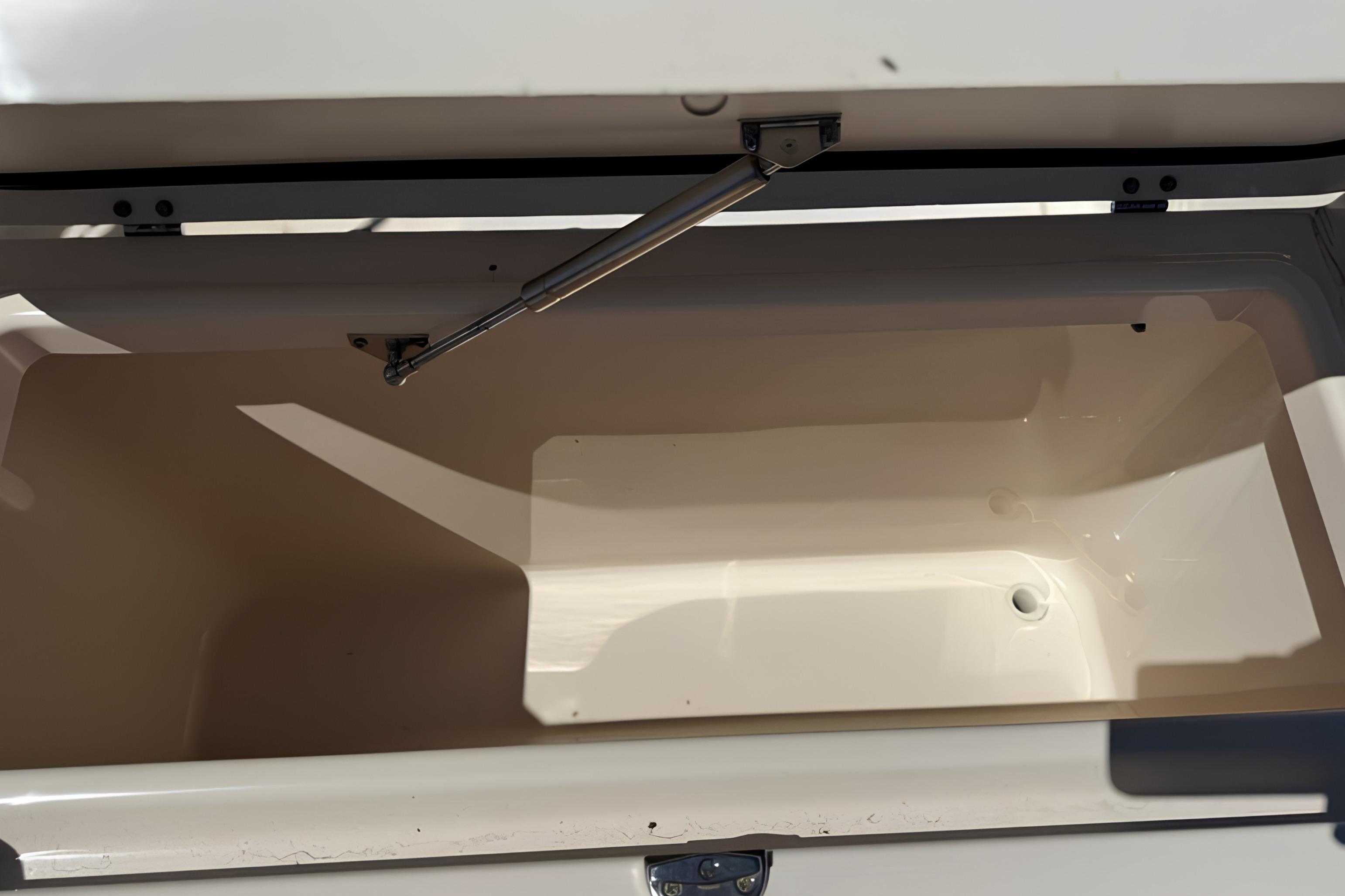 Open storage compartment on a 2017 Grady-White Freedom 235 boat.