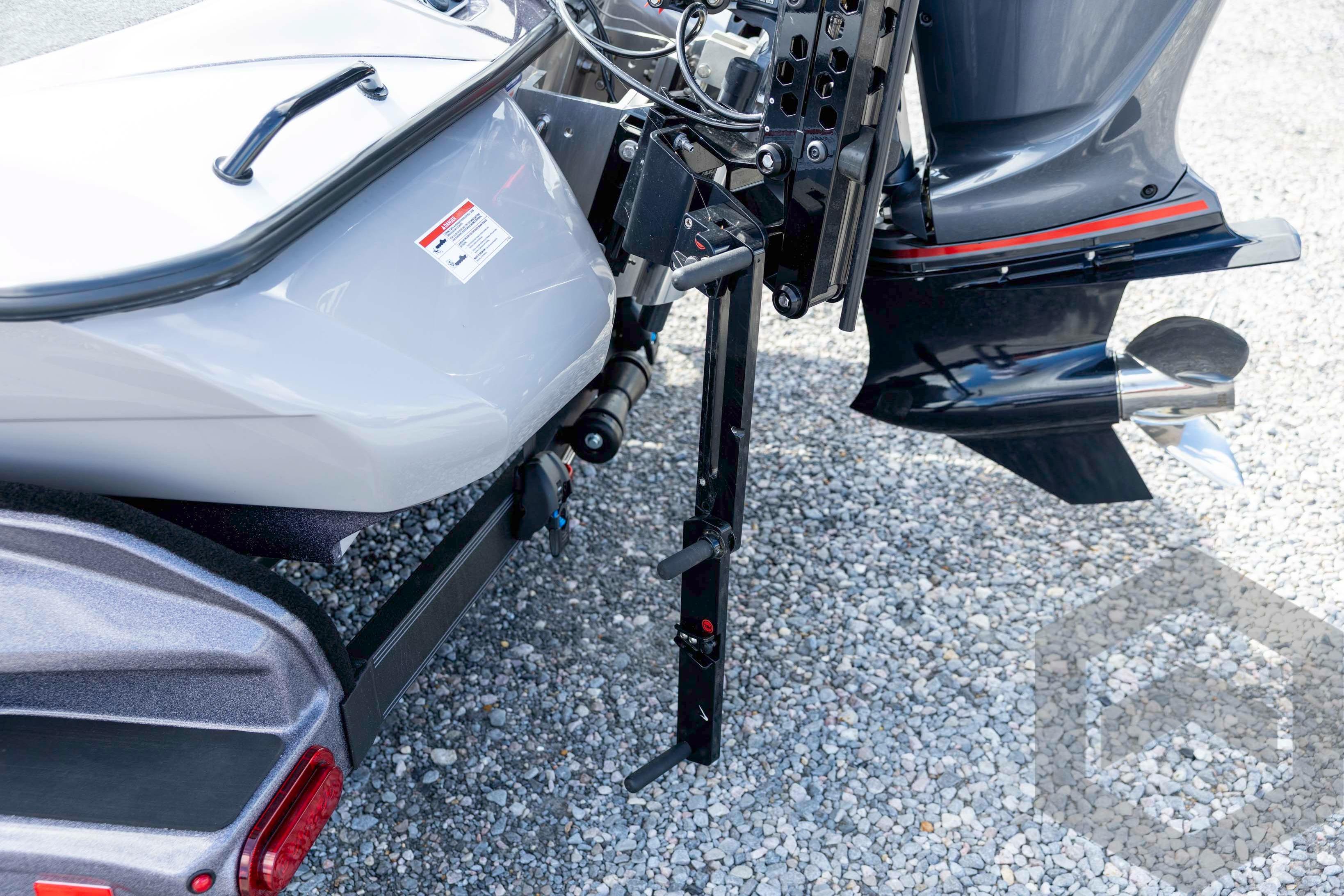 2026 Skeeter FXR20 FLEX boat trailer hitch and motor detail on gravel surface.