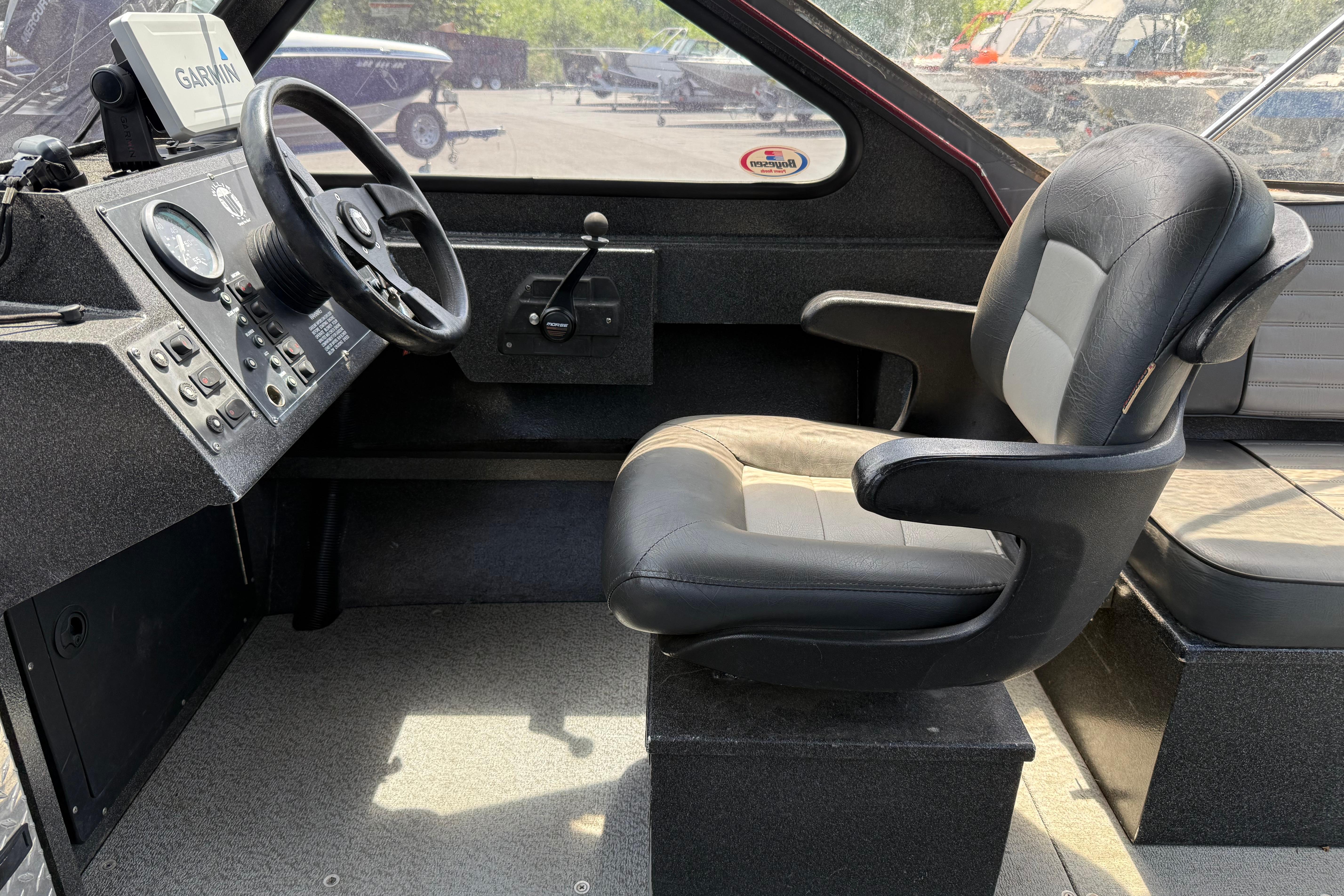Interior of a 2005 Willie Raptor 21' boat with steering wheel and seat.