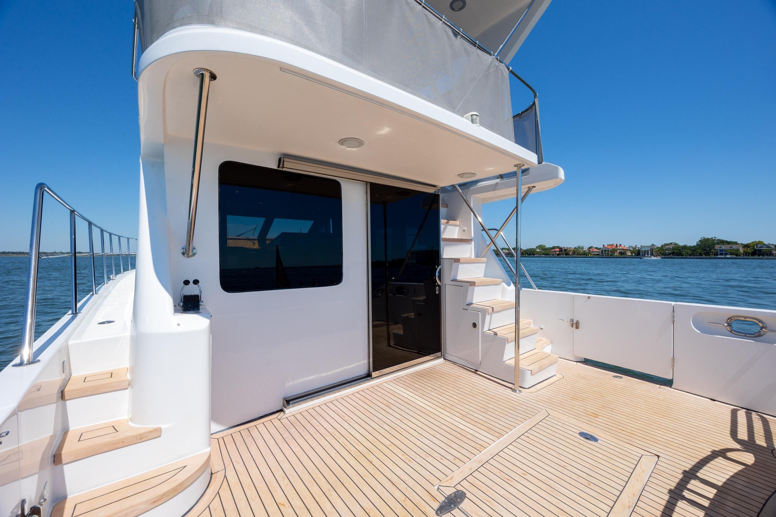 Luxury Ocean Alexander 52 Sedan yacht deck, 2005 model, with stairs and ocean view.
