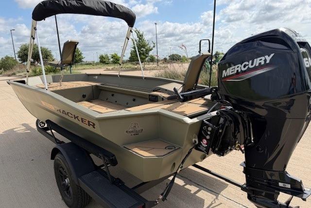 2026 Tracker Grizzly 1756 T Marsh boat with Mercury engine on trailer, outdoors.