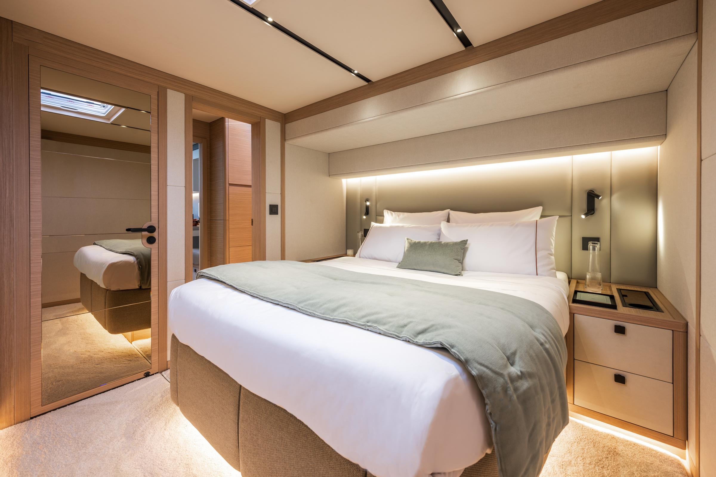 Luxurious bedroom interior of 2025 Lagoon Eighty 2 yacht with modern design and ambient lighting.