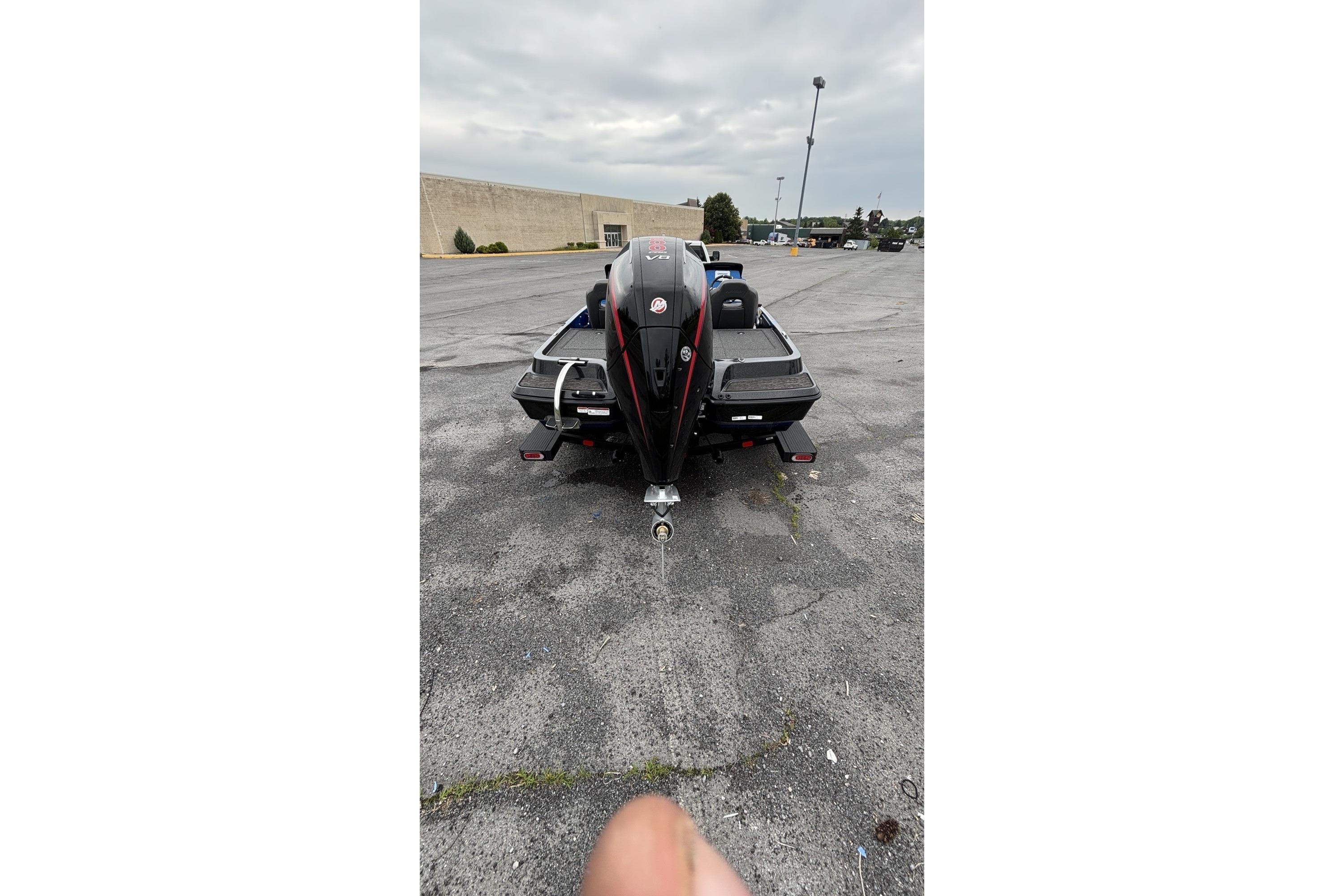 2026 Nitro Z19 XL boat rear view in parking lot, overcast sky.