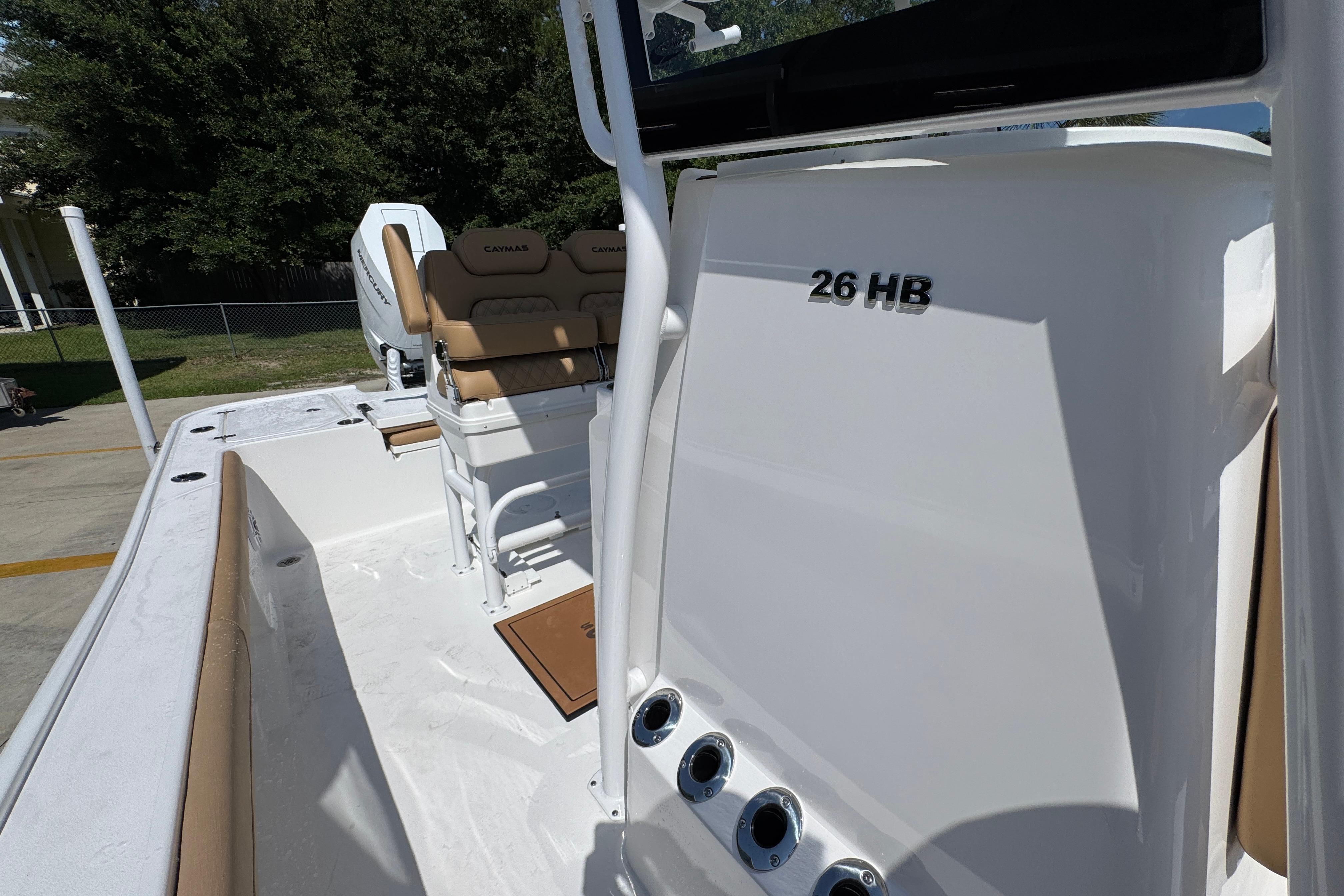 2027 Caymas 26 HB boat interior with seating and console, showcasing sleek design and functionality.