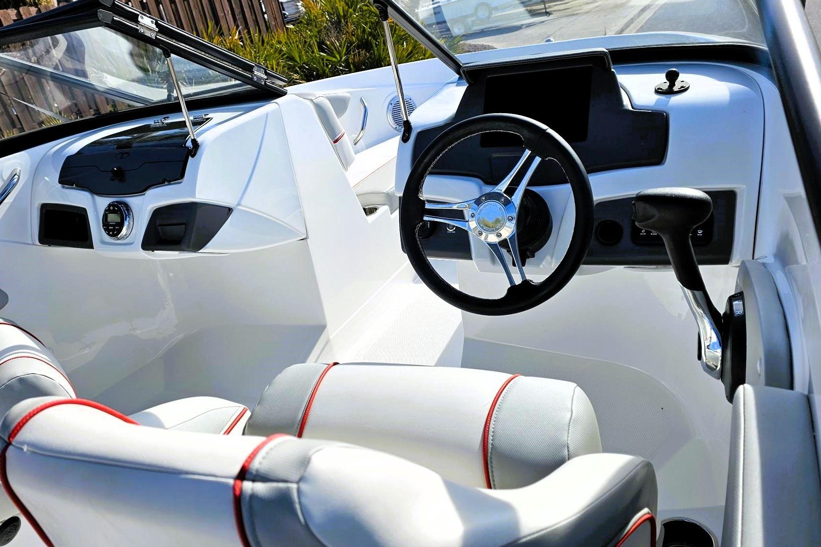 2023 Tahoe 210 Si boat interior with steering wheel and modern dashboard.