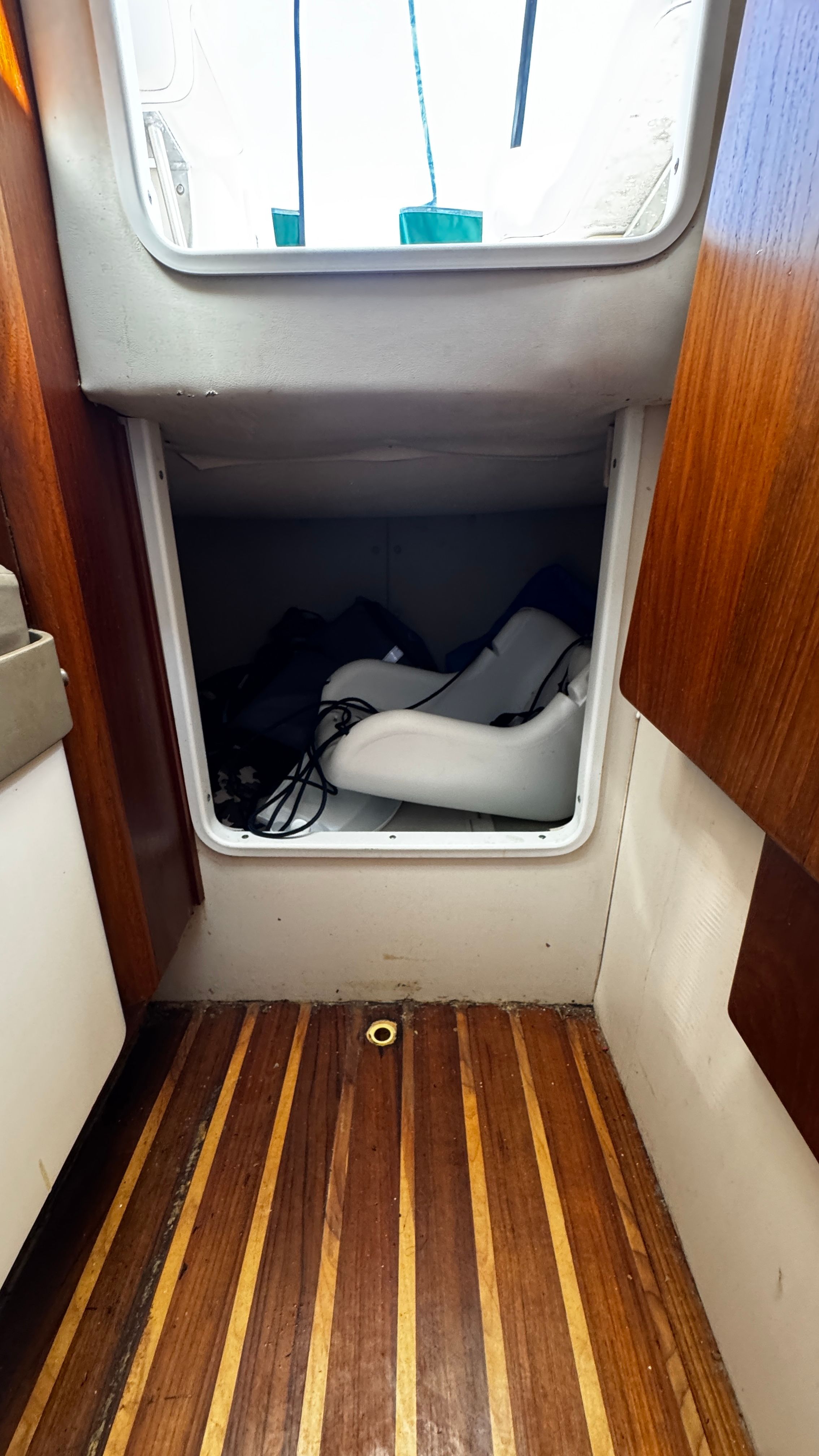 Interior of a 2003 Pursuit 3070 with wooden flooring and storage space.