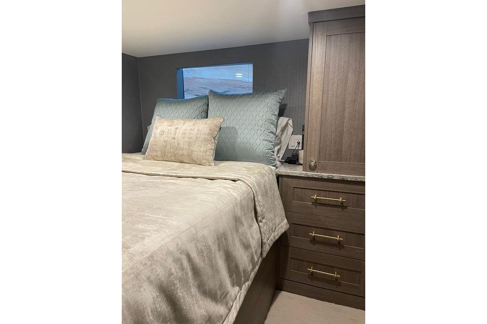 Luxurious bedroom interior in Adonia's 2021 "The Queen Elizabeth" model with elegant bedding.