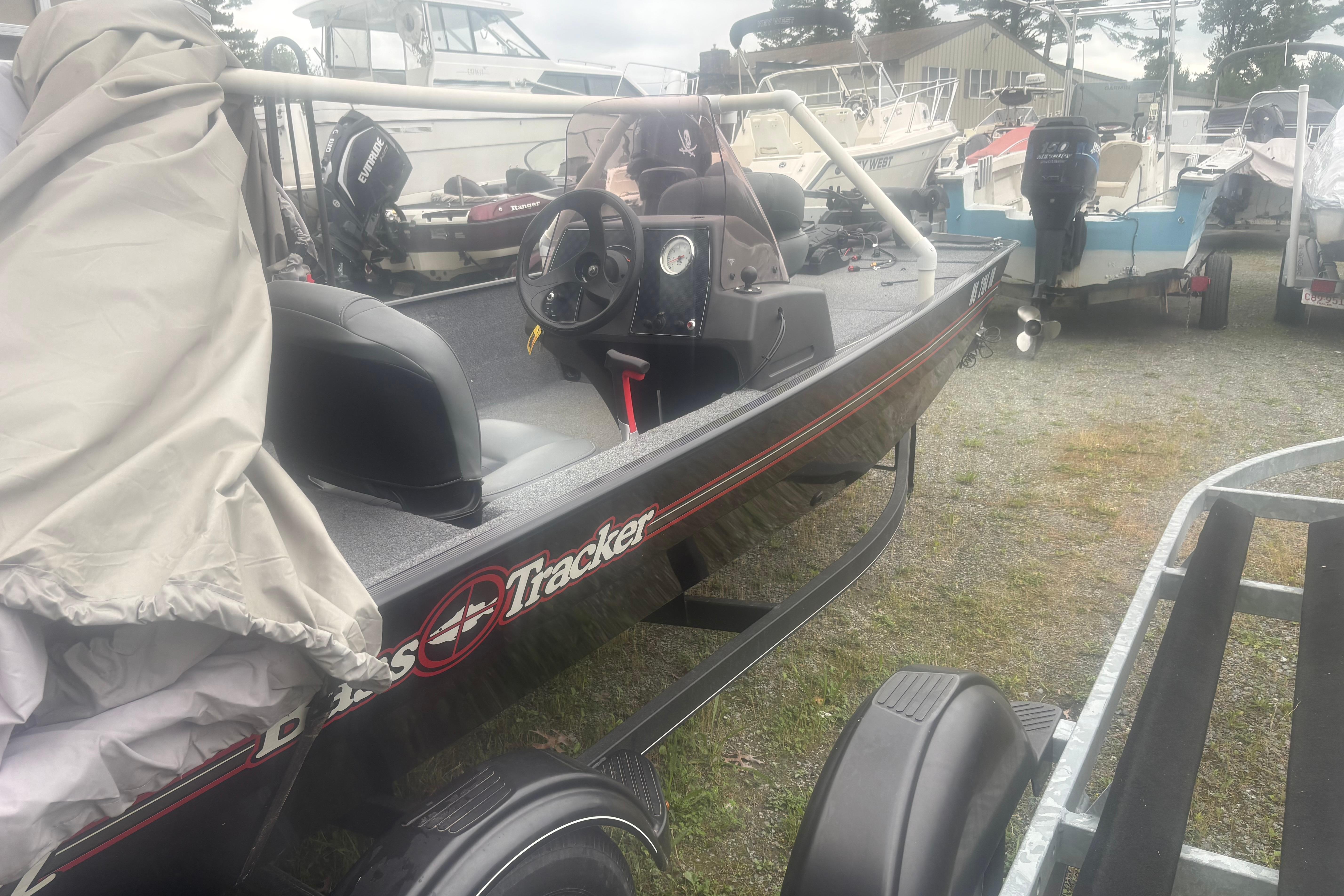 2020 Bass Tracker III Classic boat parked outdoors with other boats.