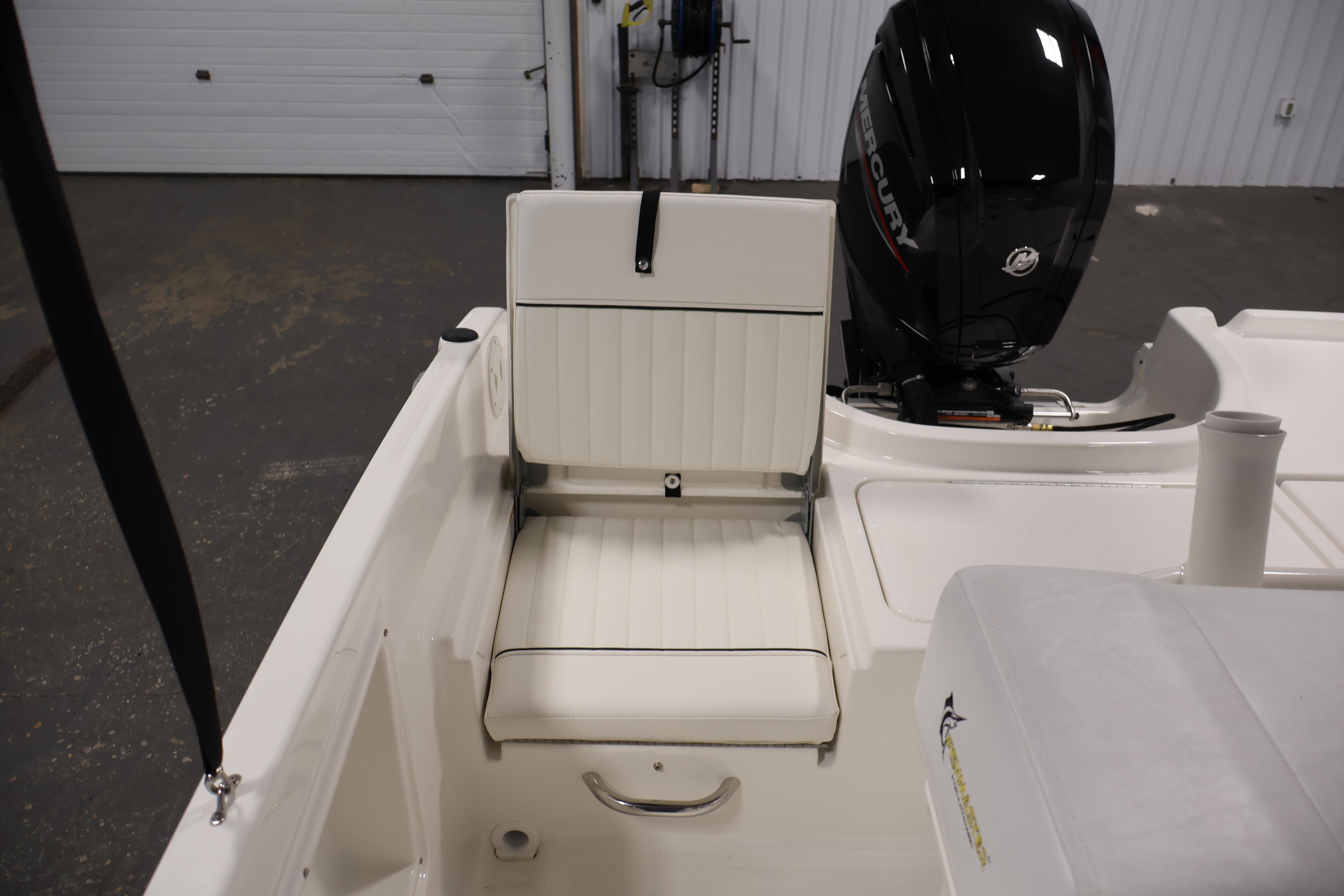 2026 Bayliner Trophy T18 boat interior with white seating and Mercury outboard motor.