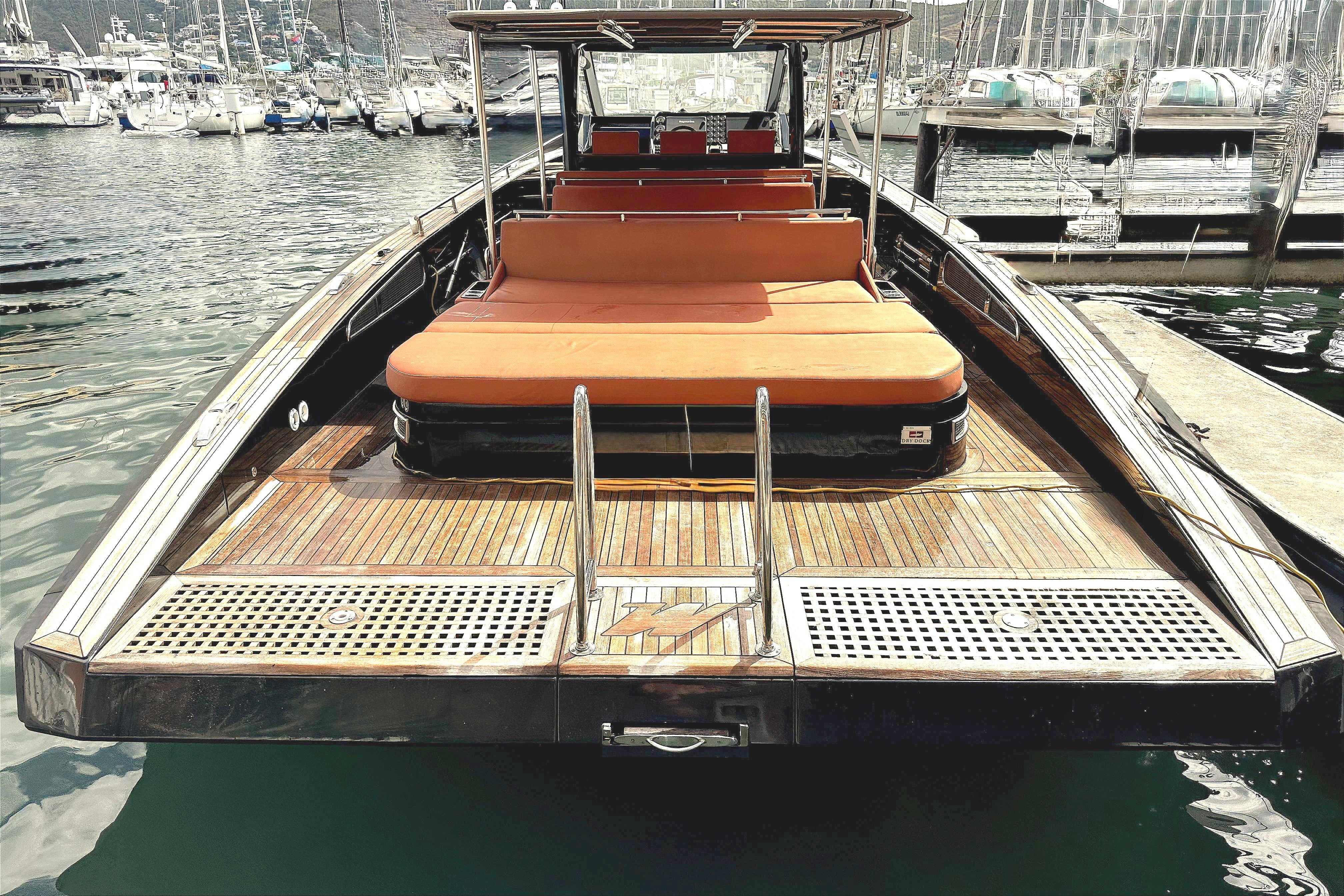 Luxury Windy SR52 yacht, 2013 model, docked at marina with wooden deck and orange seating.