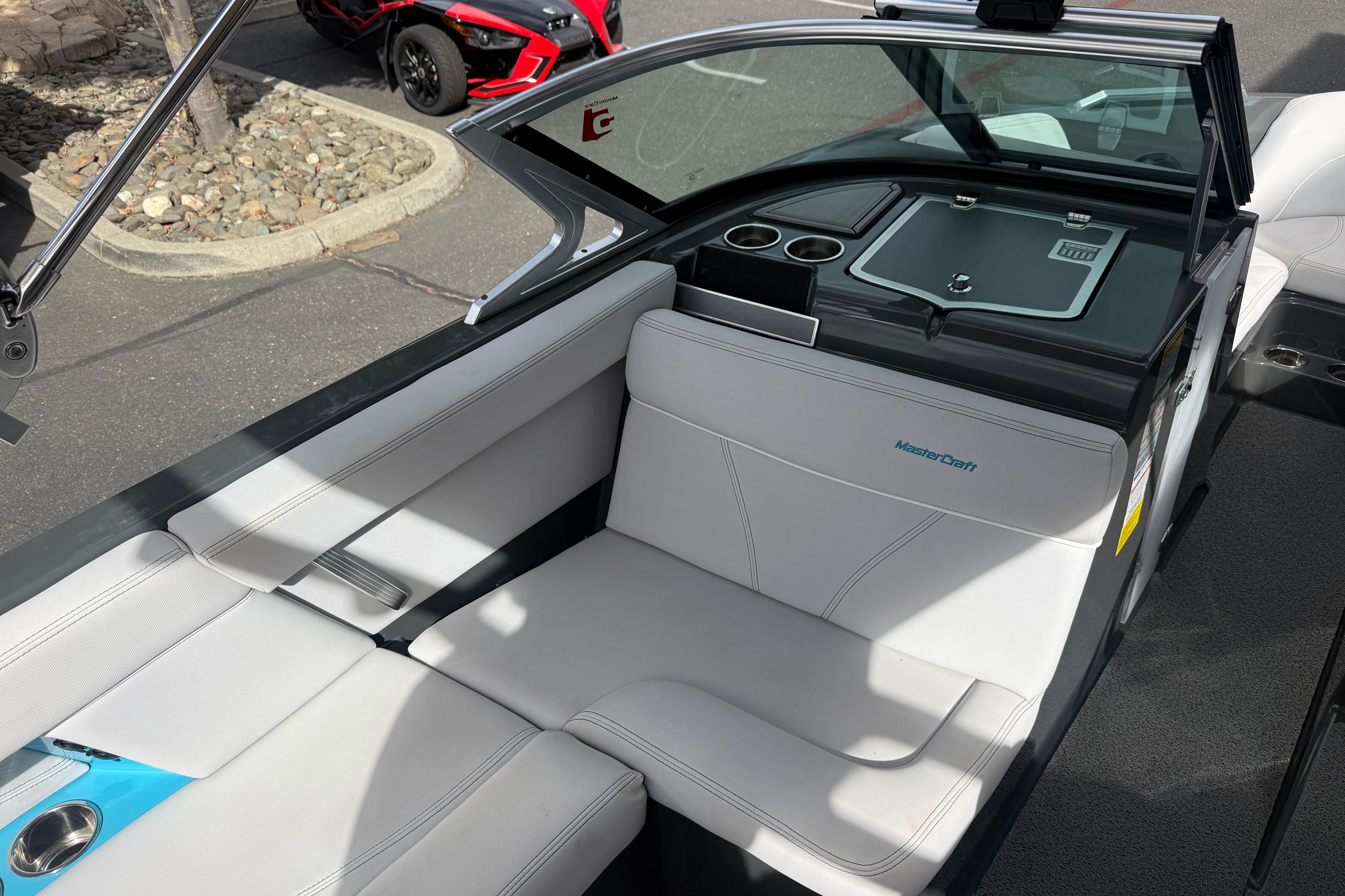 2018 MasterCraft XT21 boat interior with white seating and cup holders.