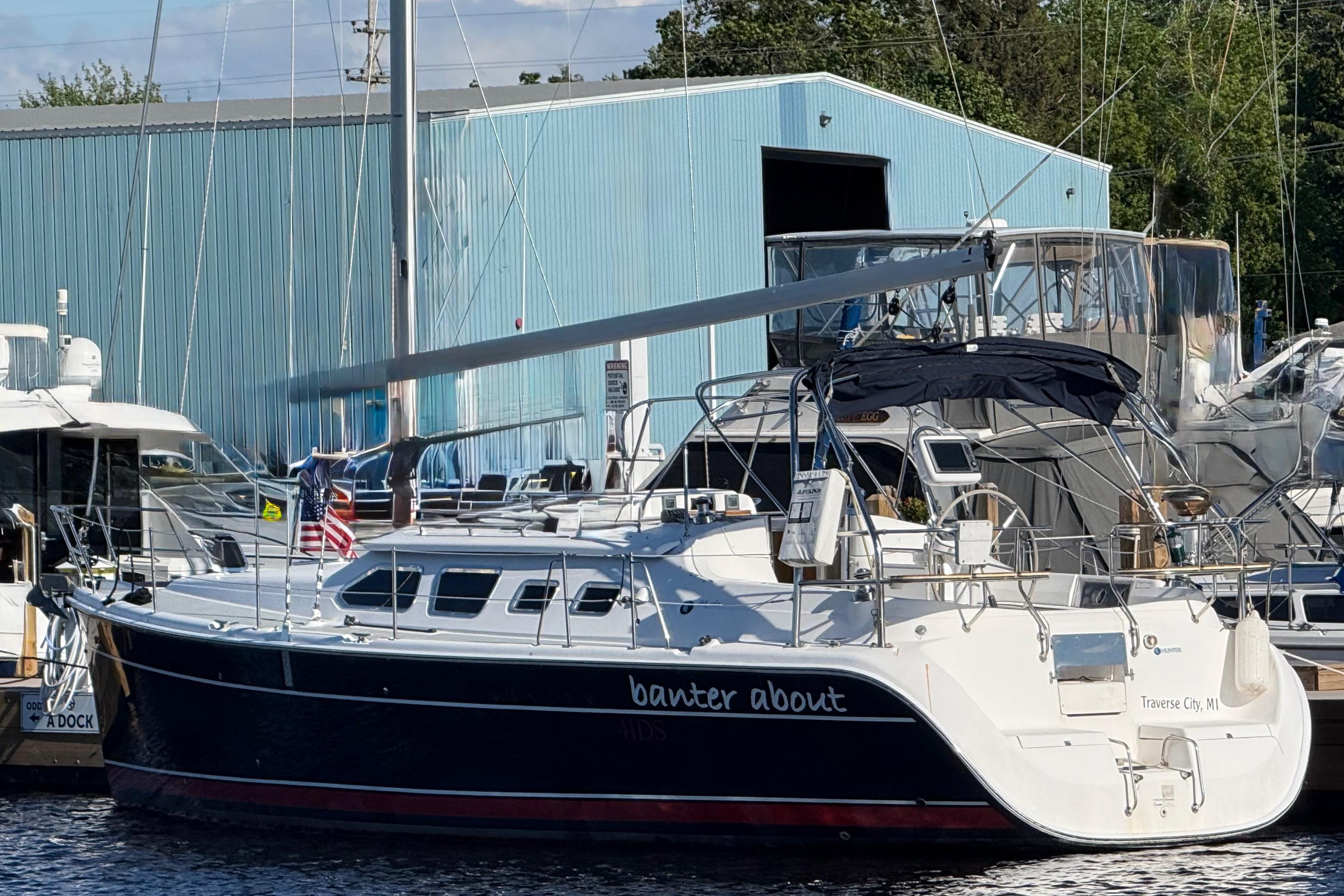 2007 Hunter 41 Deck Salon sailboat docked at marina, blue hull, Traverse City, MI.