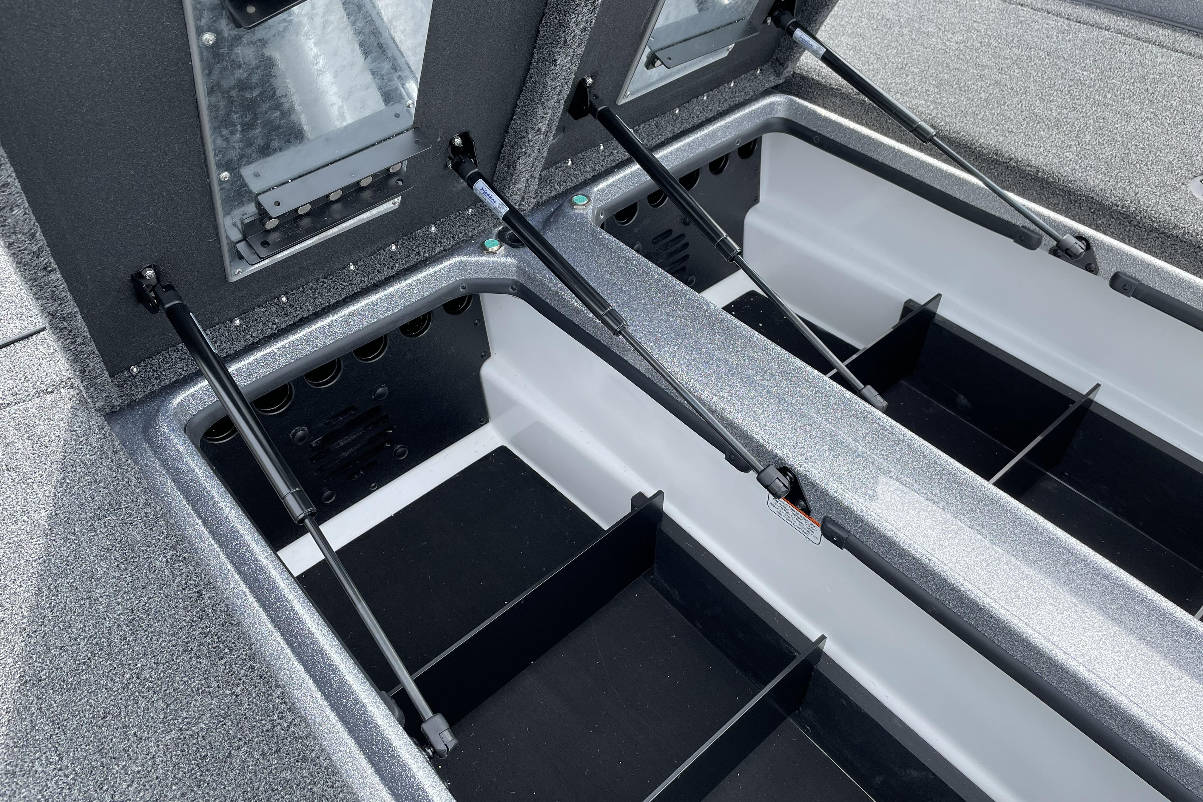 2026 Nitro Z21 XL boat storage compartments with hydraulic lifts and organized interior layout.