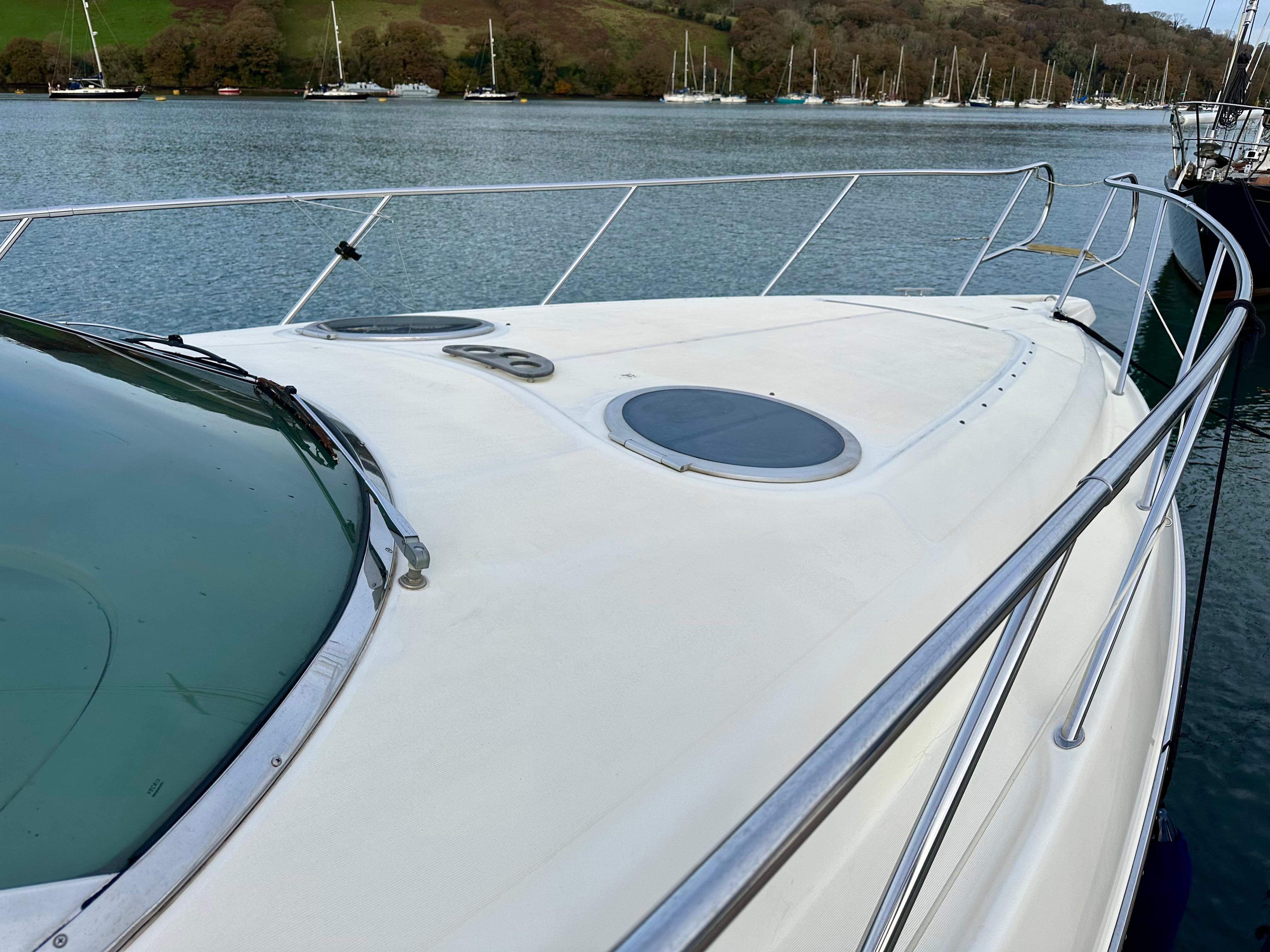1999 Cranchi Endurance 39 yacht on calm water, showcasing sleek deck design.