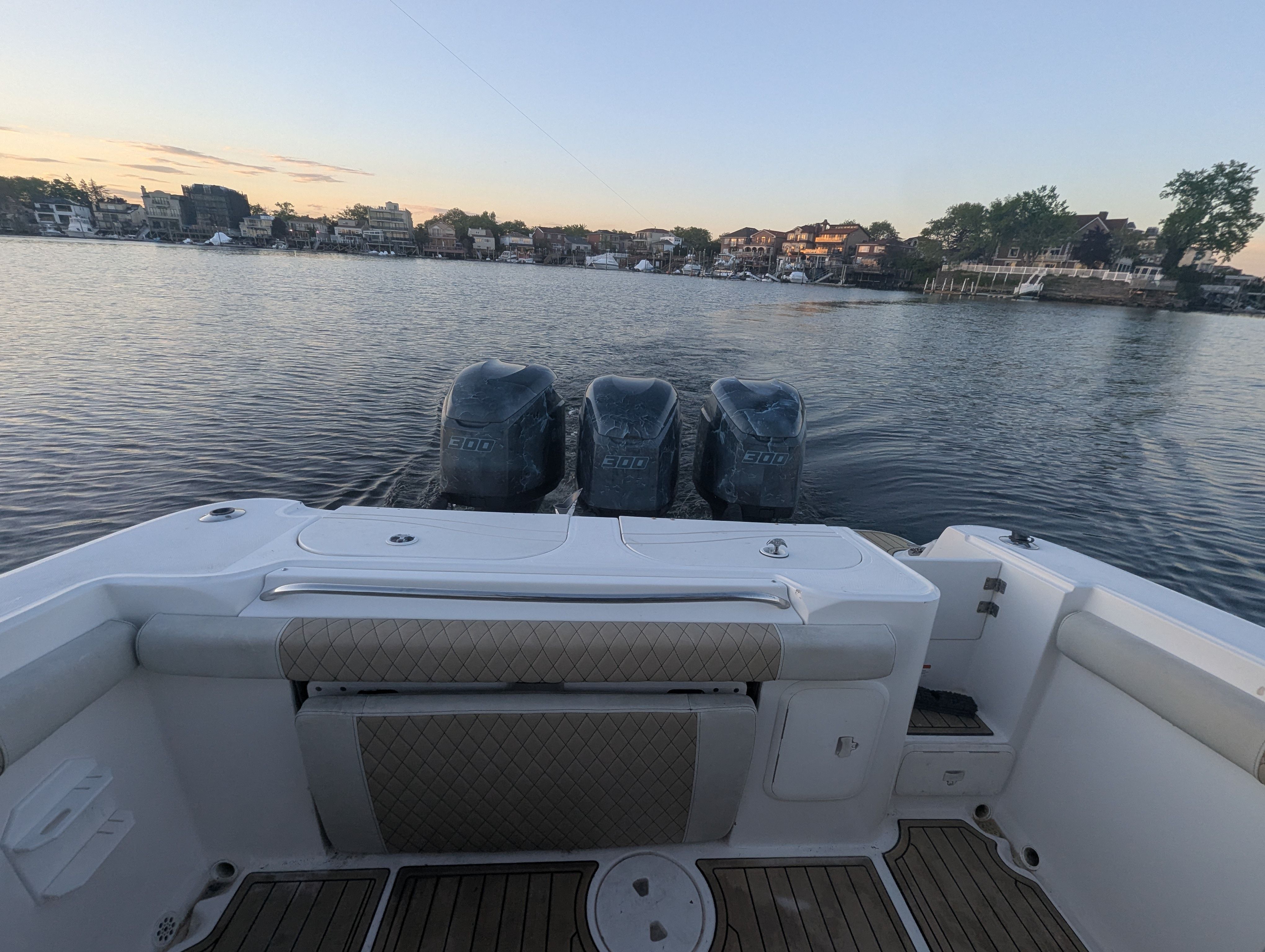 Wellcraft 35 CCF 2005 boat with three outboard engines on calm water.