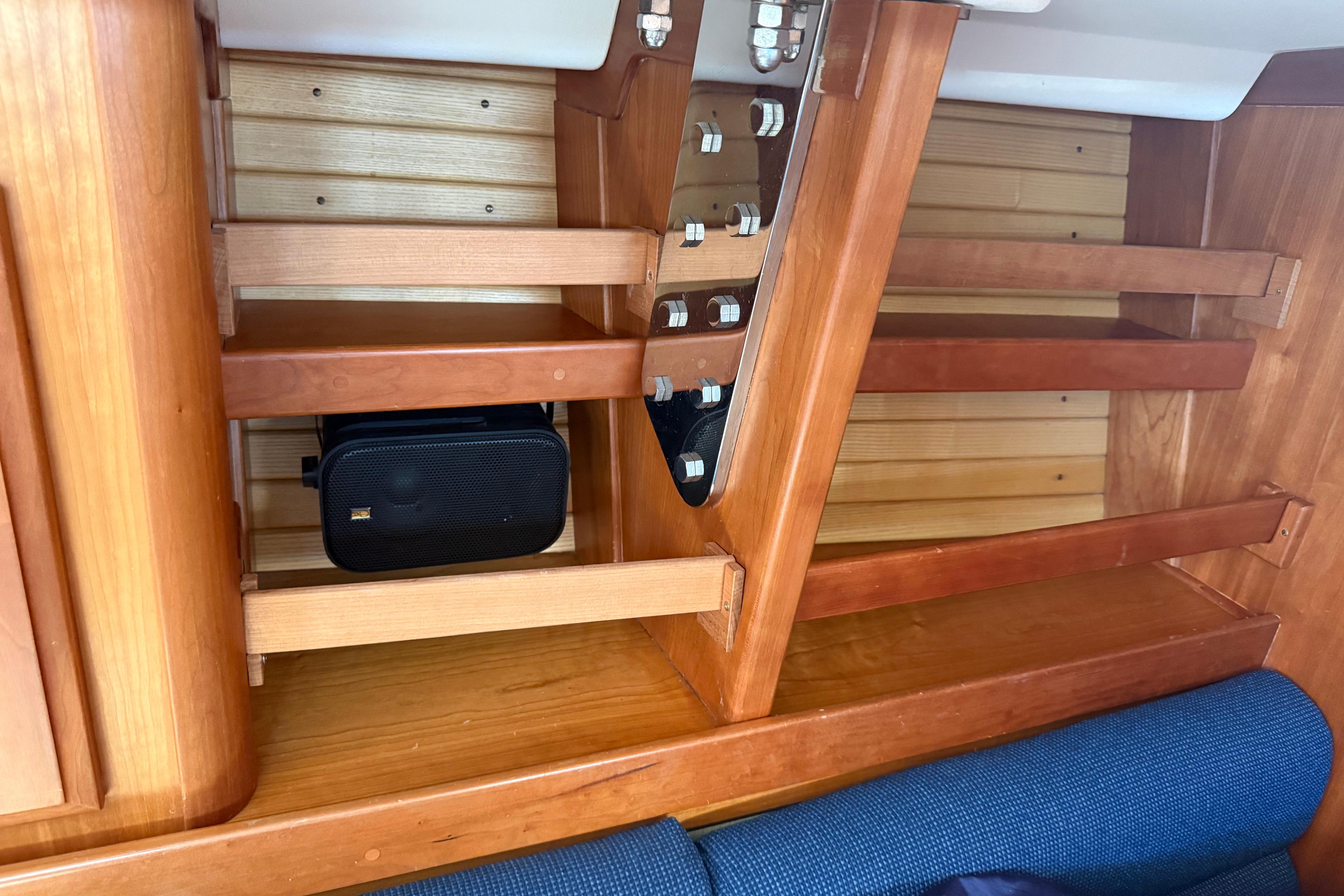 Wooden interior shelving on a 2004 Sabre 386 sailboat, featuring secure storage space.