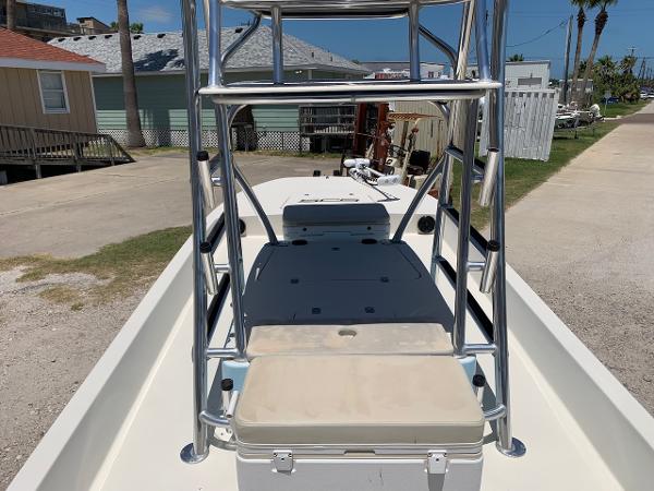 2013 SCB R24 boat with elevated seating and aluminum frame, parked outdoors.