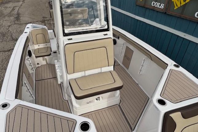 2026 Yamaha Boats 222 FSH Sport E interior with beige seating and sleek design.