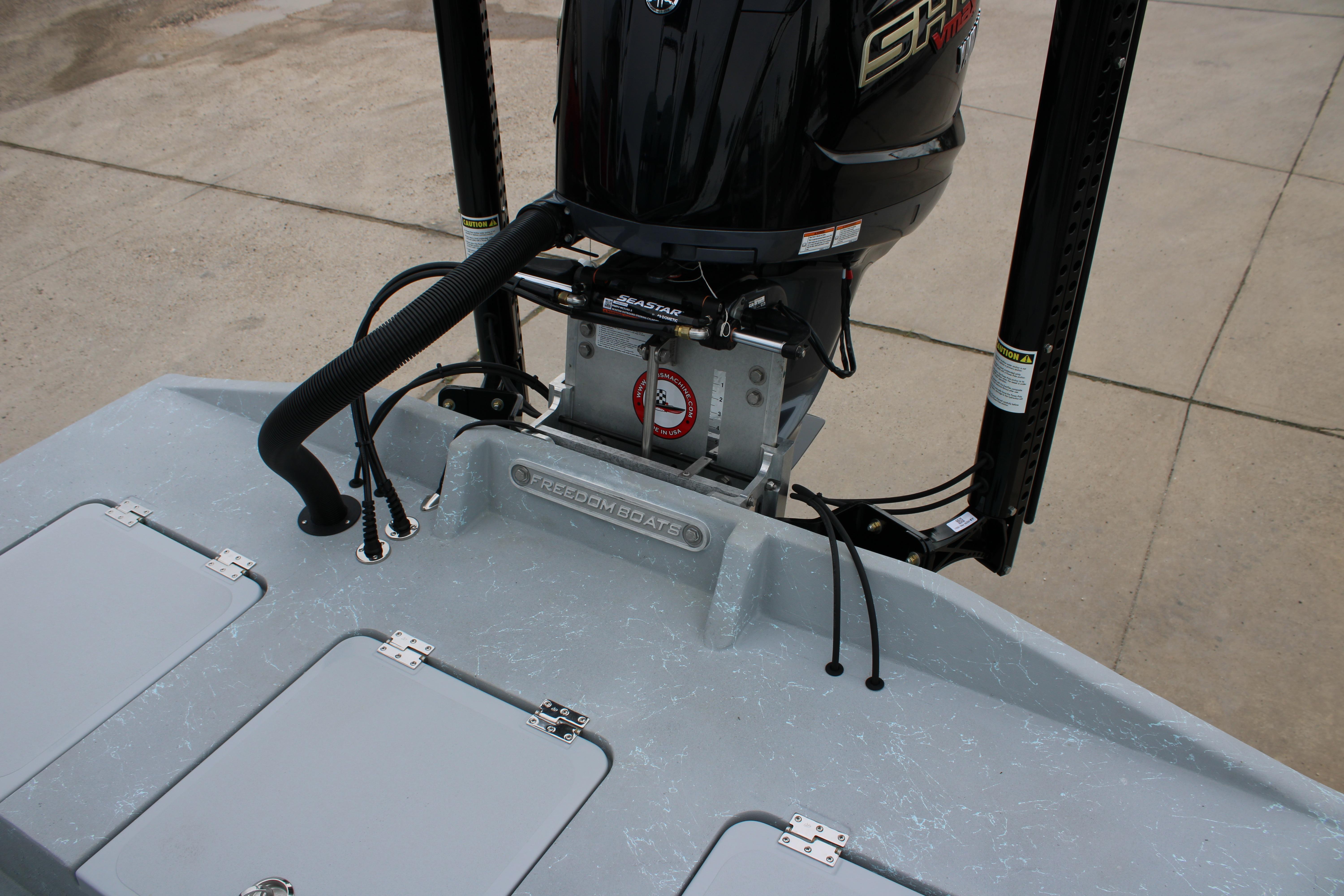 2026 Freedom Boats 24 Defender with powerful outboard motor on deck.