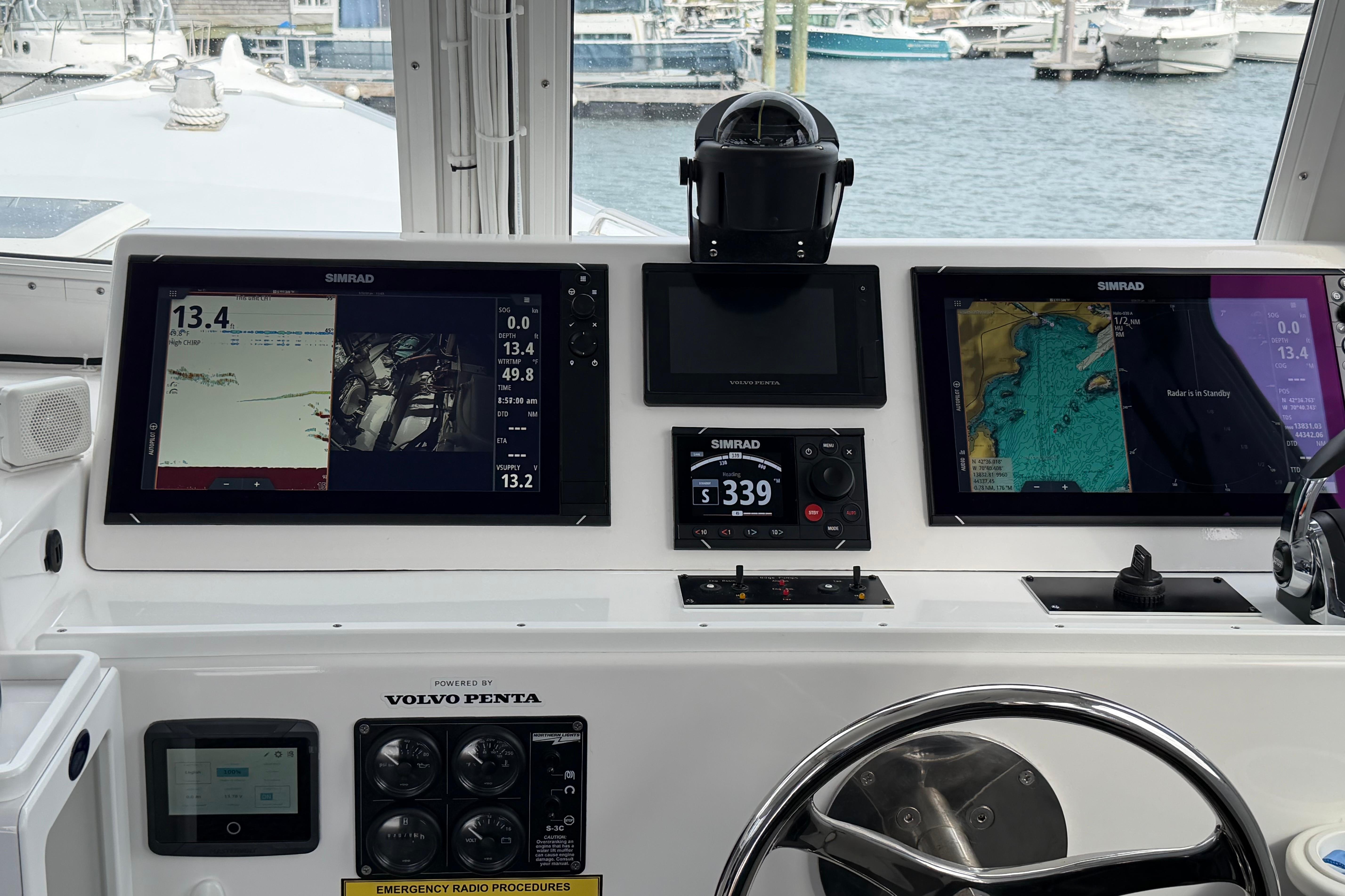 Helm of 2018 H&H Marine Osmond Beal boat with Simrad navigation displays.