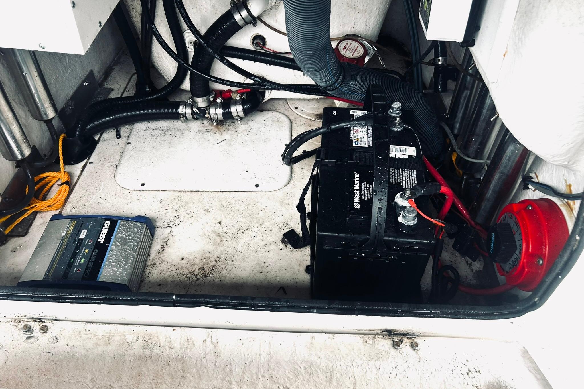 Battery compartment of a 2017 Blue Wave 2200 PureBay boat, featuring wiring and equipment.