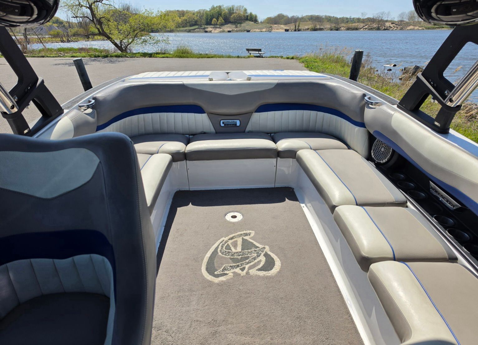 Interior of a 2014 Malibu Wakesetter 24 MXZ boat by the lake.