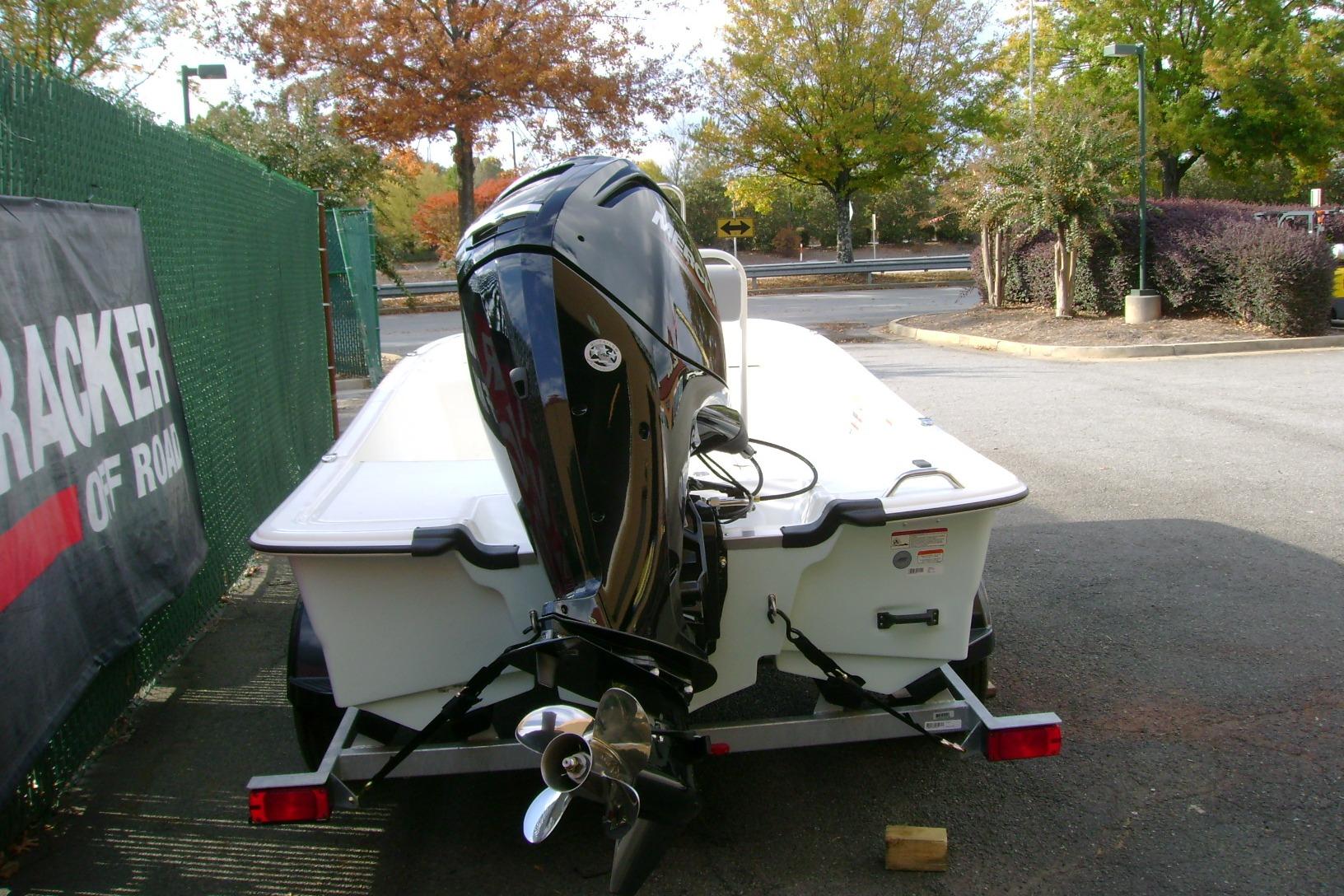 2026 Mako Pro Skiff 17 CC boat on trailer, parked outdoors with autumn trees.