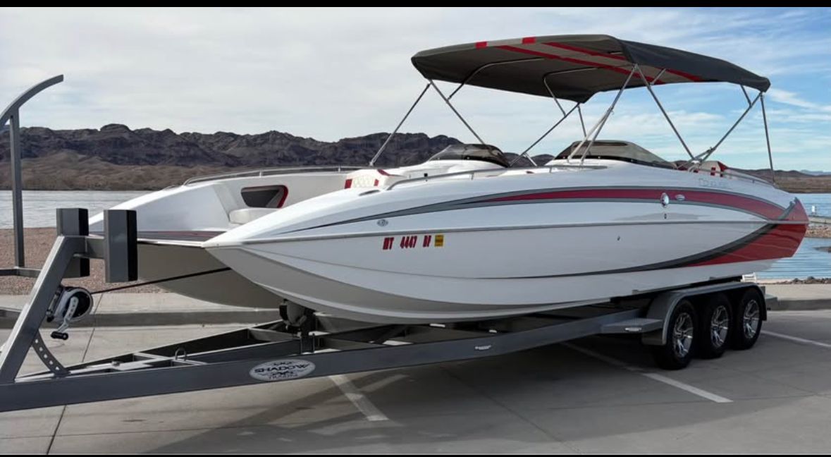 2022 Conquest 28’ Top Cat II Deck Boat on trailer by lake.
