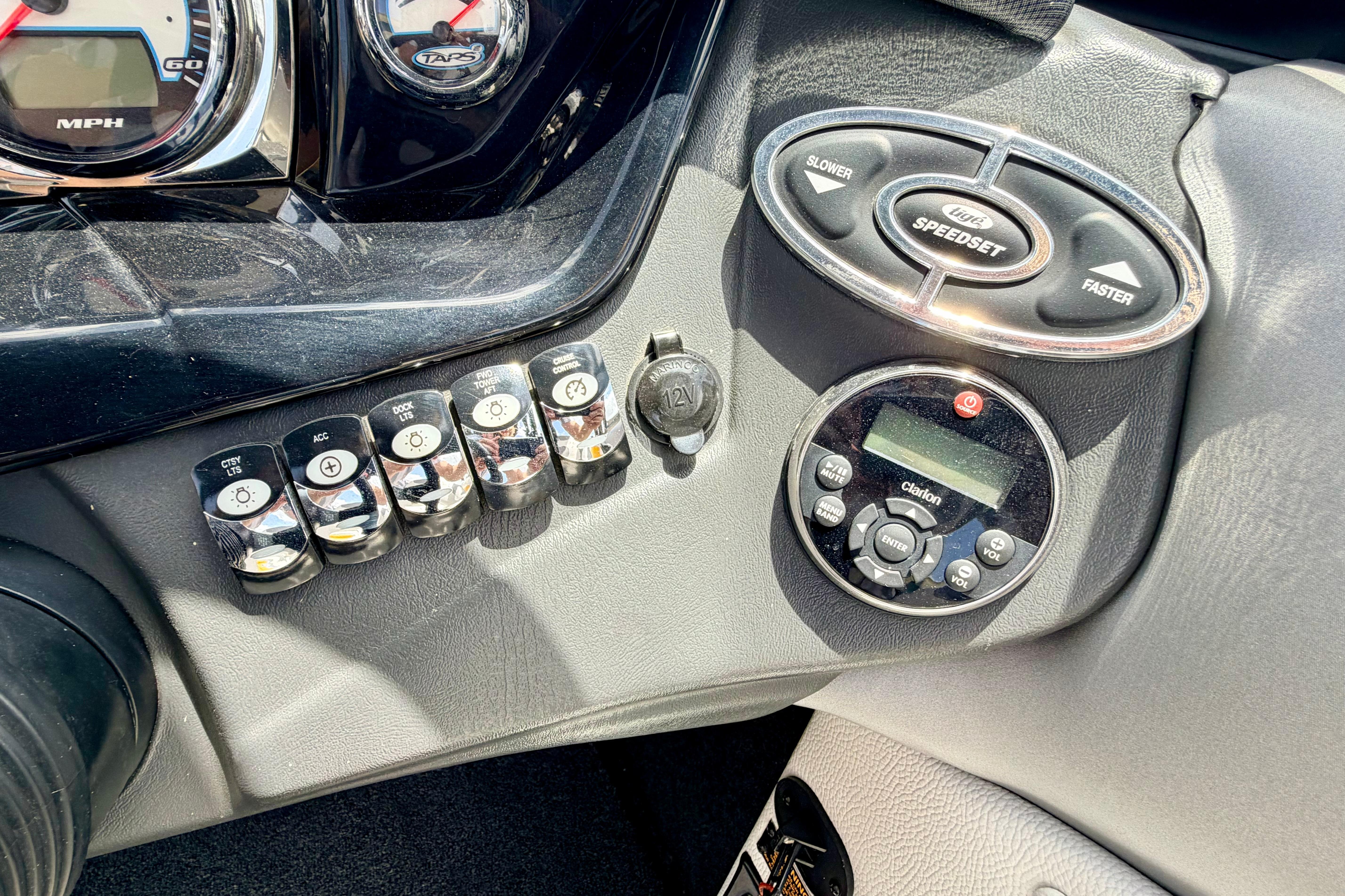 Dashboard controls of a 2014 Tigé R20 boat, featuring gauges and switches.