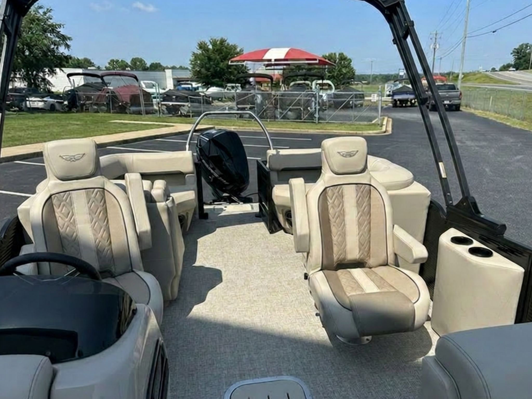 The image shows the interior of a 2026 Bennington 22 MFB boat with beige seating.