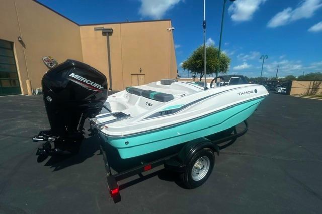 2026 Tahoe T16 boat with Mercury engine on trailer, parked outdoors.