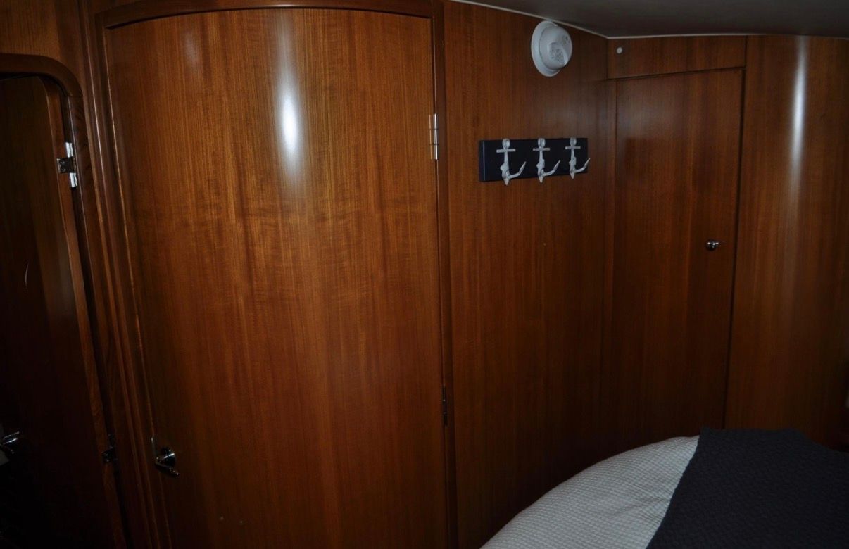 Interior of a 2005 Tiara Yachts 5200 Sovran with wooden walls and anchor hooks.