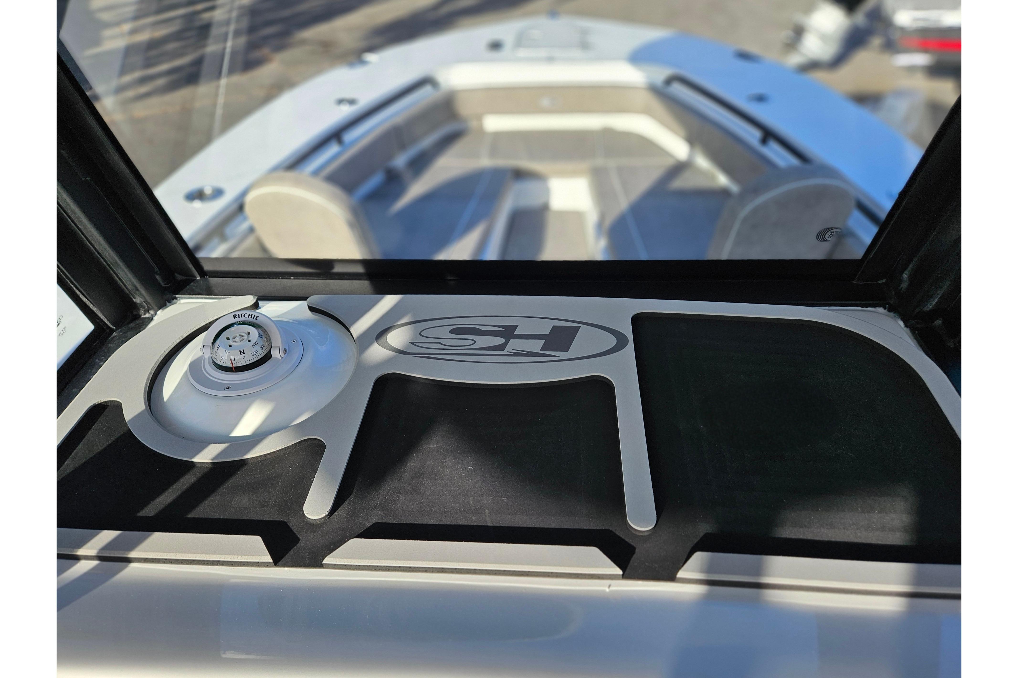 2026 Sea Hunt Ultra 285 SE boat interior with compass and logo detail.