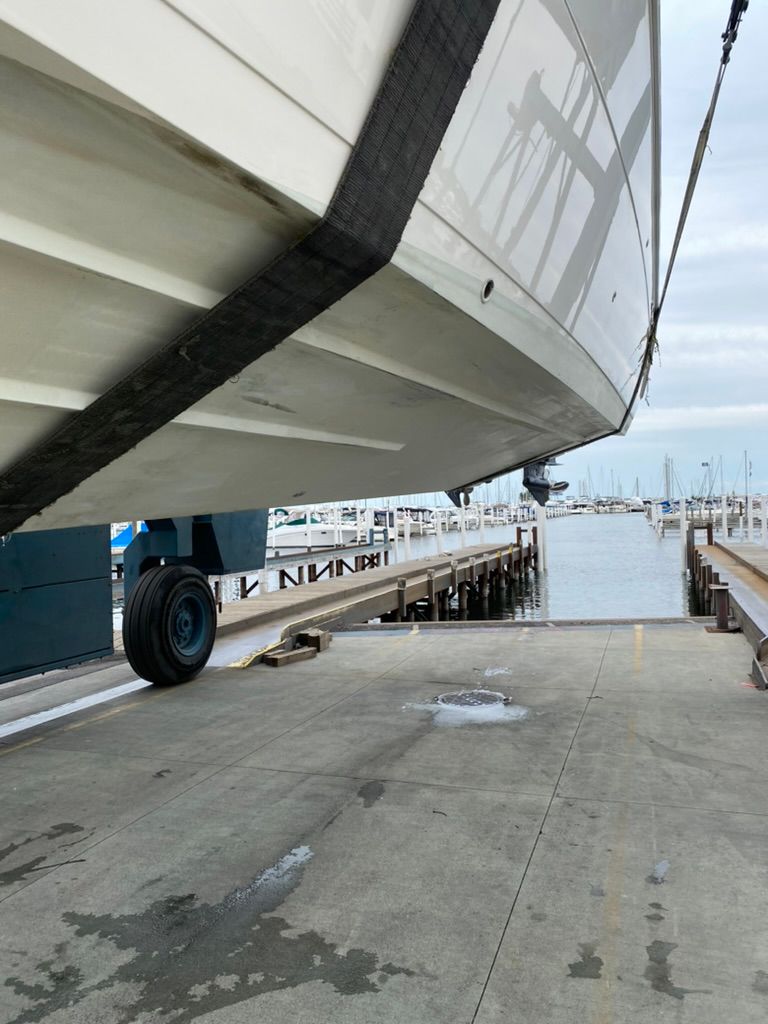 2023 Cobia 330 boat being lifted at the marina.