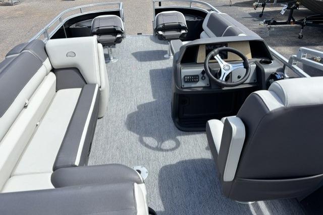 2026 Sun Tracker Fishin' Barge 22 DLX interior with seating and steering console.