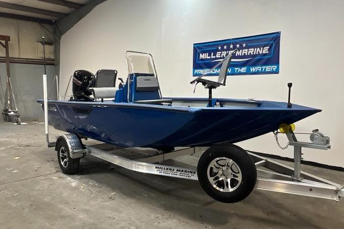 2025 SeaArk Shadow 187T boat on trailer in showroom, blue color, Miller's Marine sign.