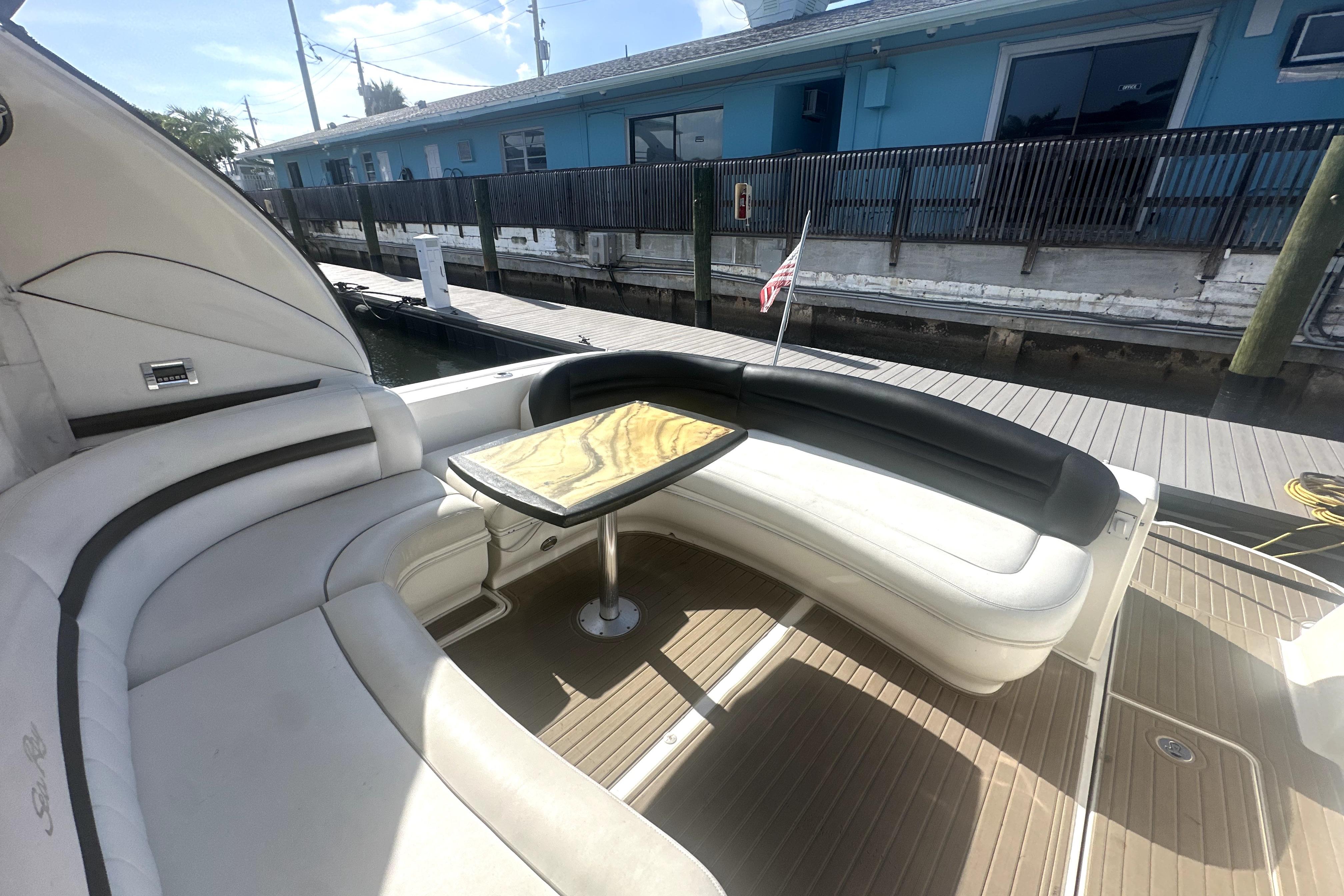 Luxurious seating area on a 2007 Sea Ray 44 Sundancer yacht with elegant table.