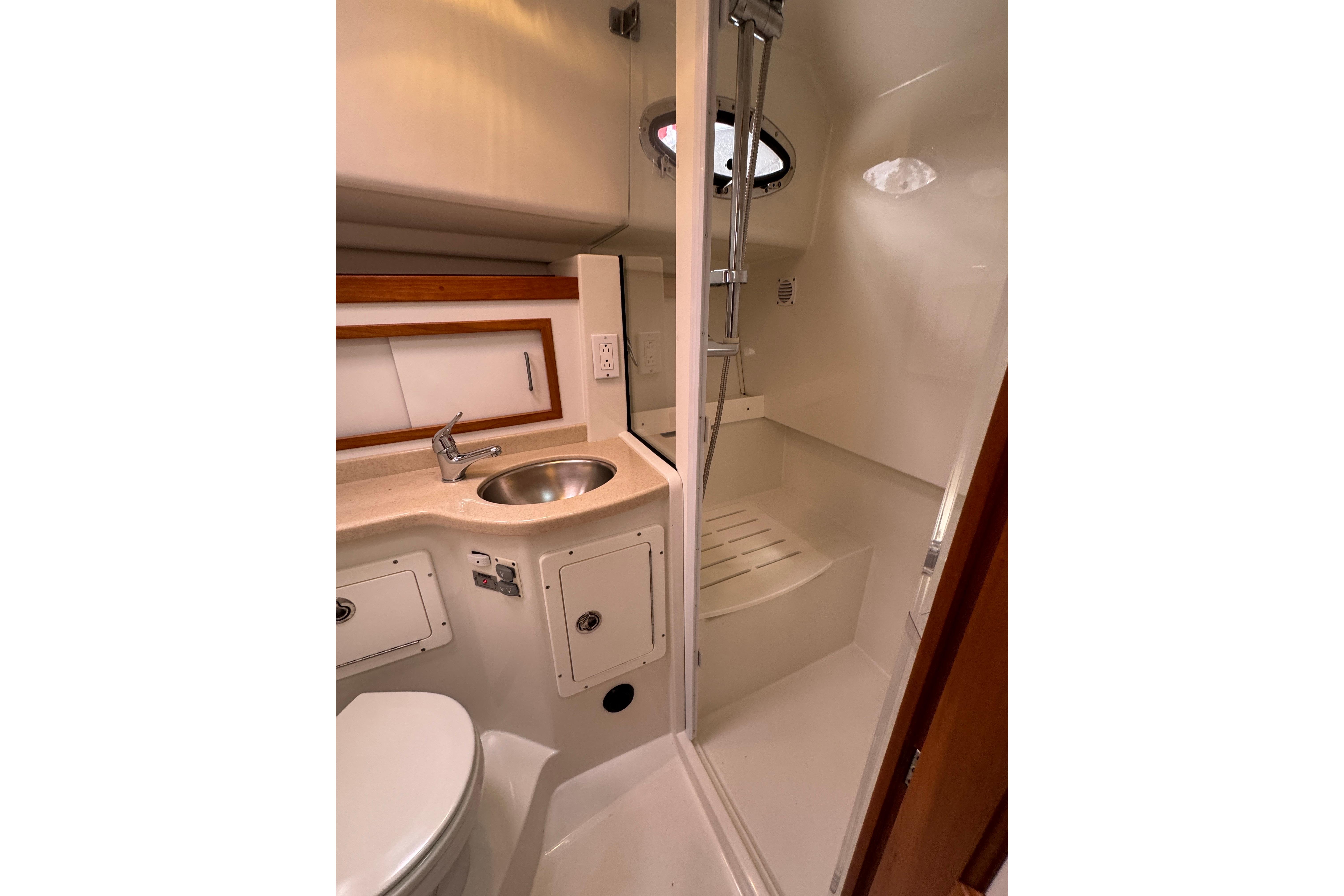 2008 Back Cove 33 yacht bathroom with shower, sink, and toilet in compact design.