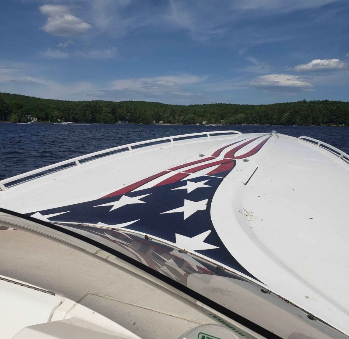 Fountain Fever 2000 boat with American flag design on lake.