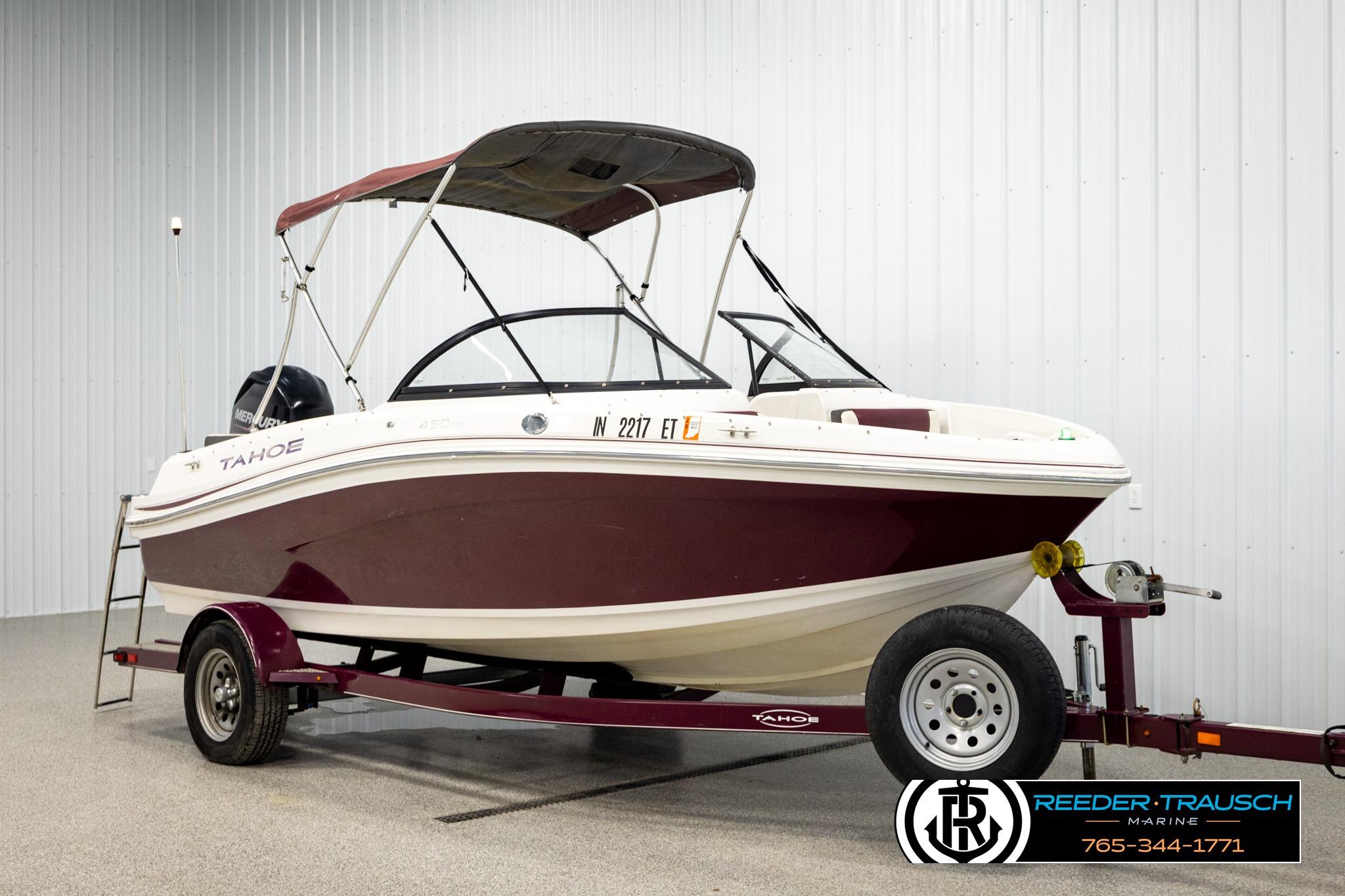 2016 Tahoe 450 TS boat on trailer in indoor showroom setting.