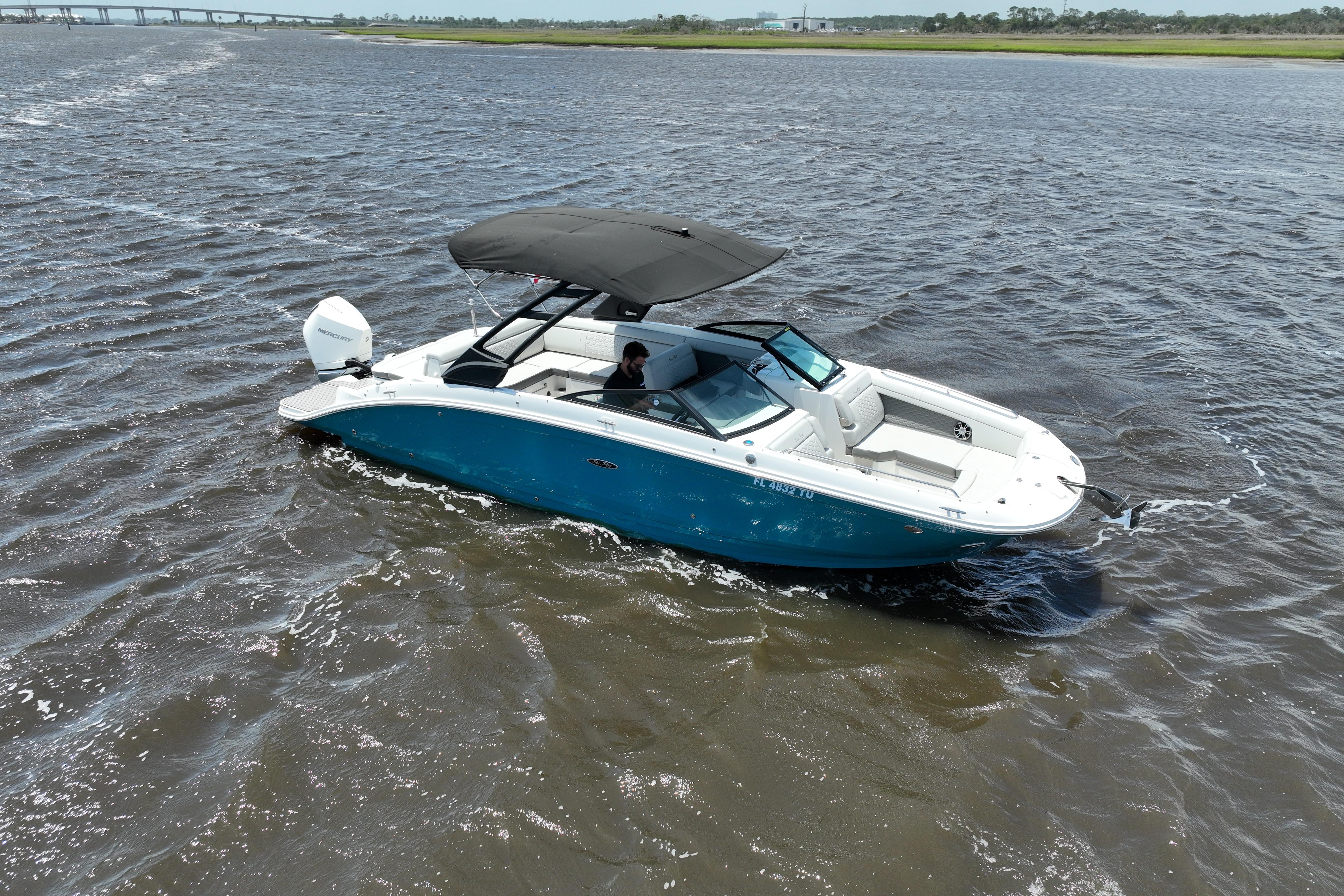 2024 Sea Ray SDX 270 Outboard cruising on open water, featuring sleek design and spacious seating.