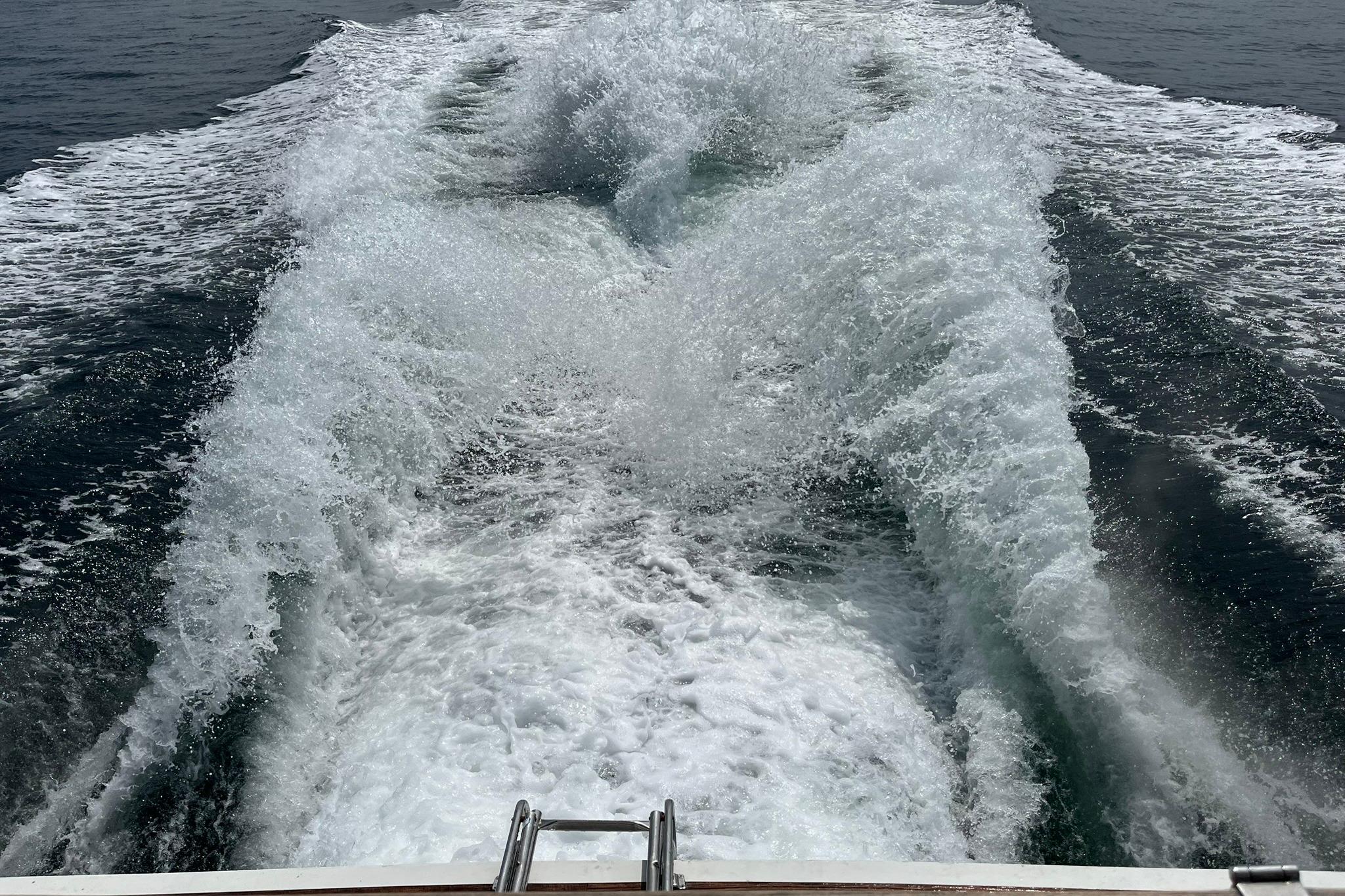 Wake of a 2002 Norris Custom Motor Catamaran 41.4 cruising through open water.